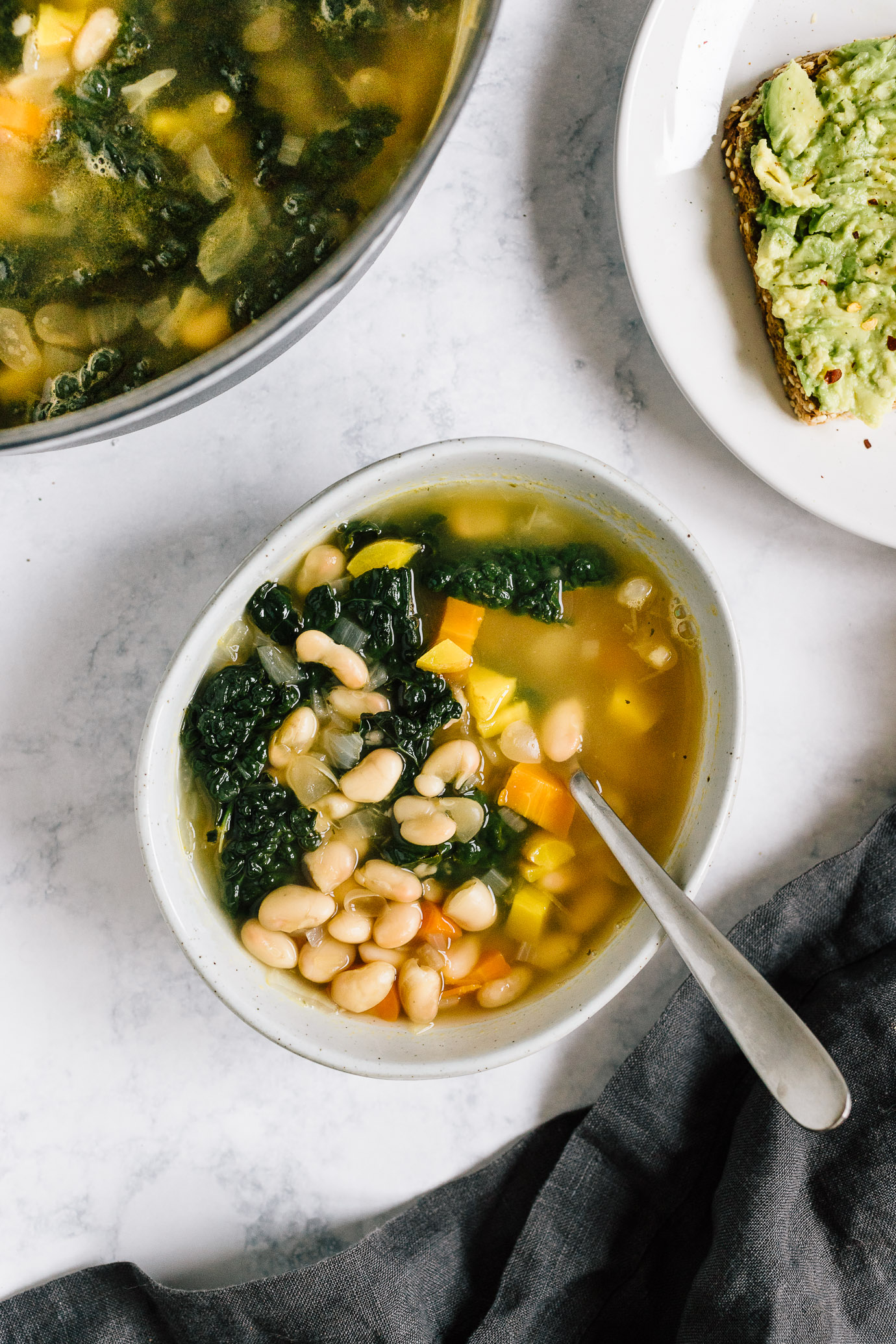 bowl of kale and white bean soup with lemon