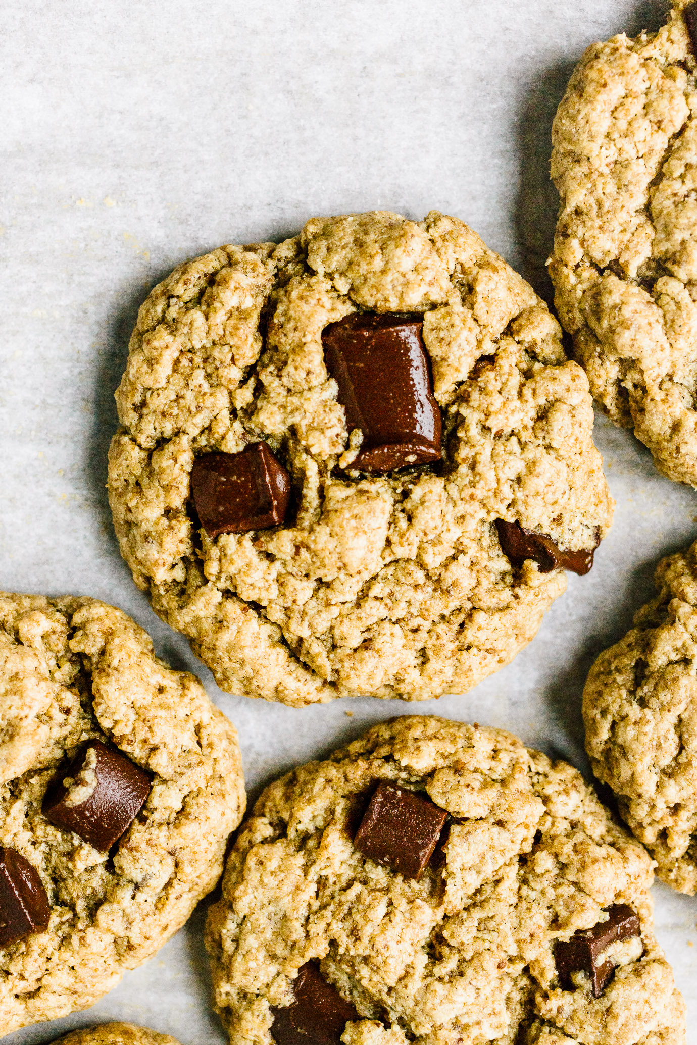 close up chocolate chip tahini cookies on parchment paper