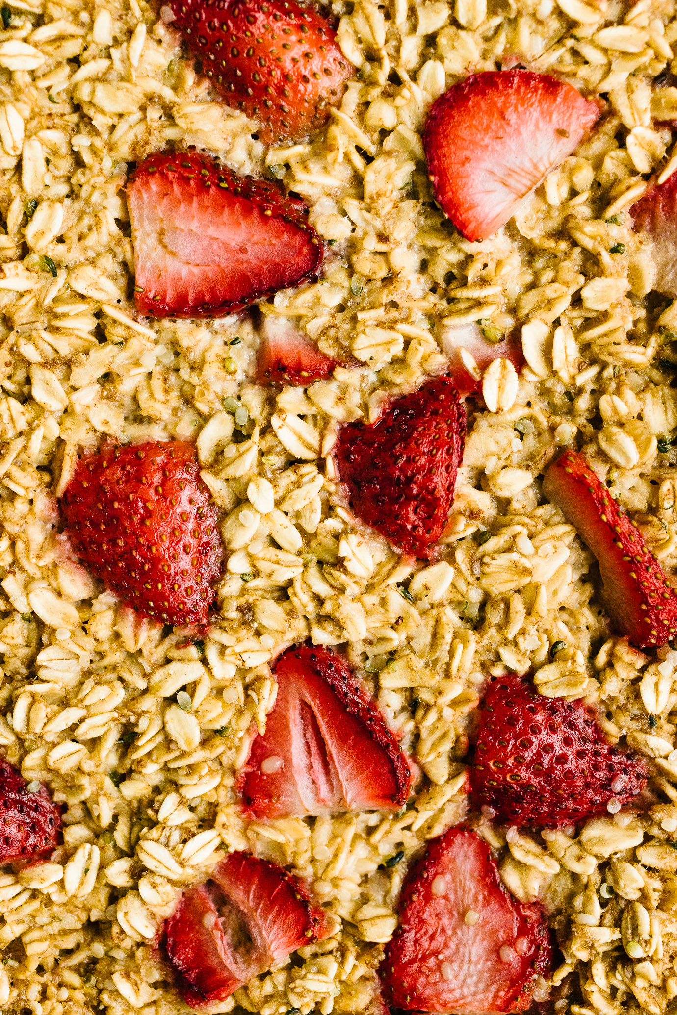 close up of baked oatmeal studded with strawberries