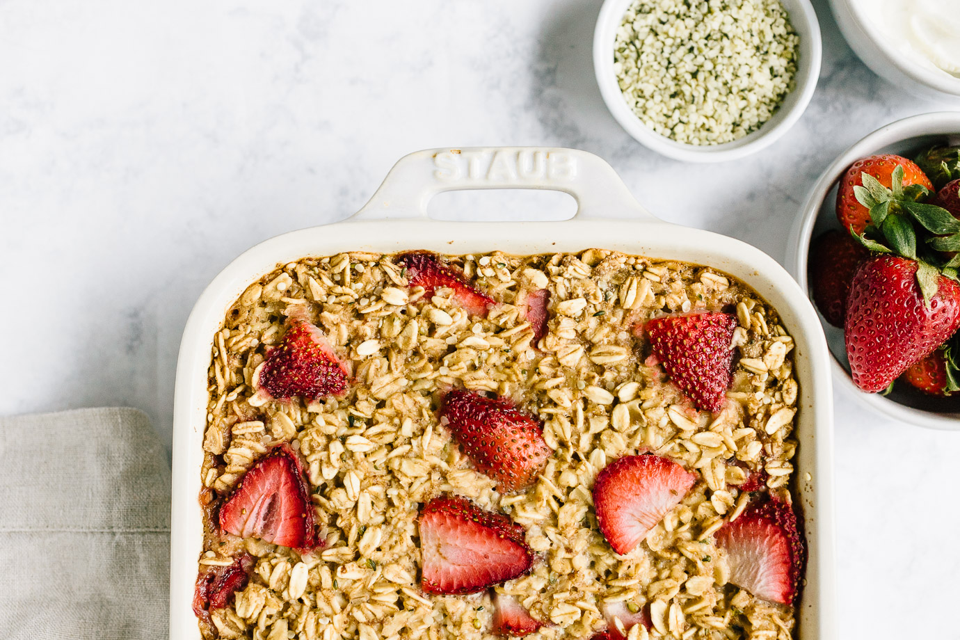 strawberry baked oatmeal with ingredients in bowls