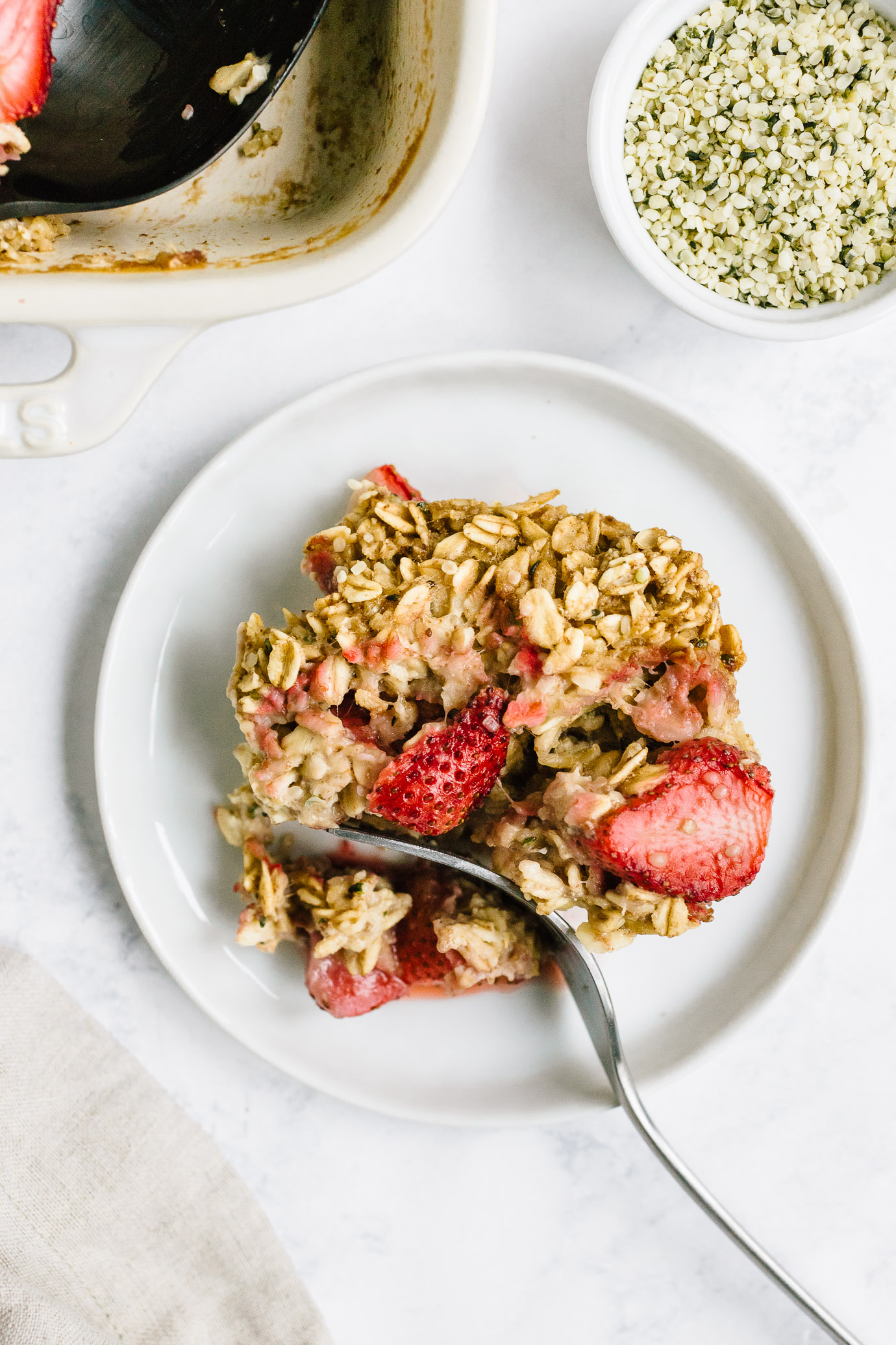 fork cutting a slice strawberry baked oatmeal 