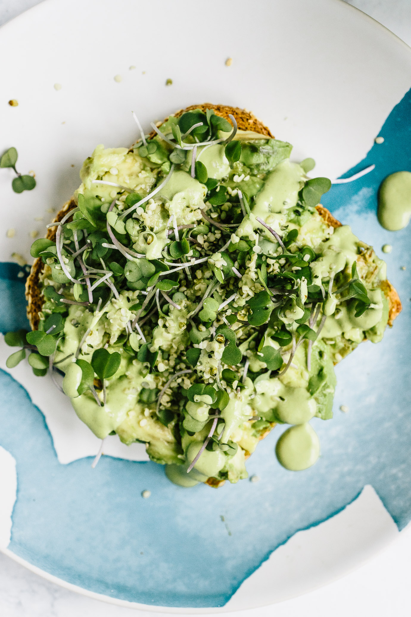 green goddess avocado toast with hemp seeds, microgreens and basil cashew cream