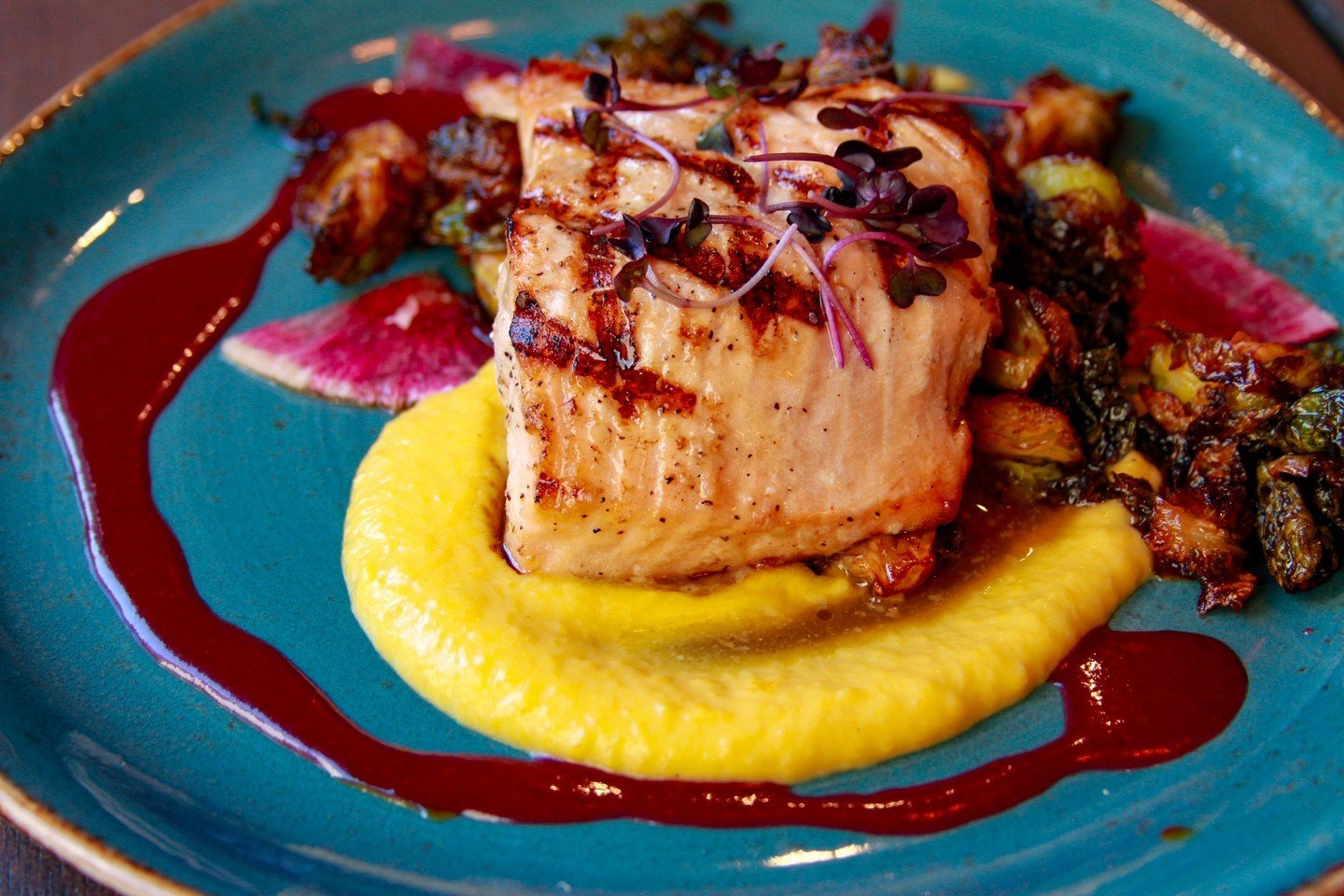 Set sail with us tomorrow for a taste of the sea! Our Atlantic Salmon awaits, served with creamy butternut squash puree, tangy black cherry gastrique, local radish, and crispy Brussels. We're closed Sundays, but Monday brings a fresh catch to your pl