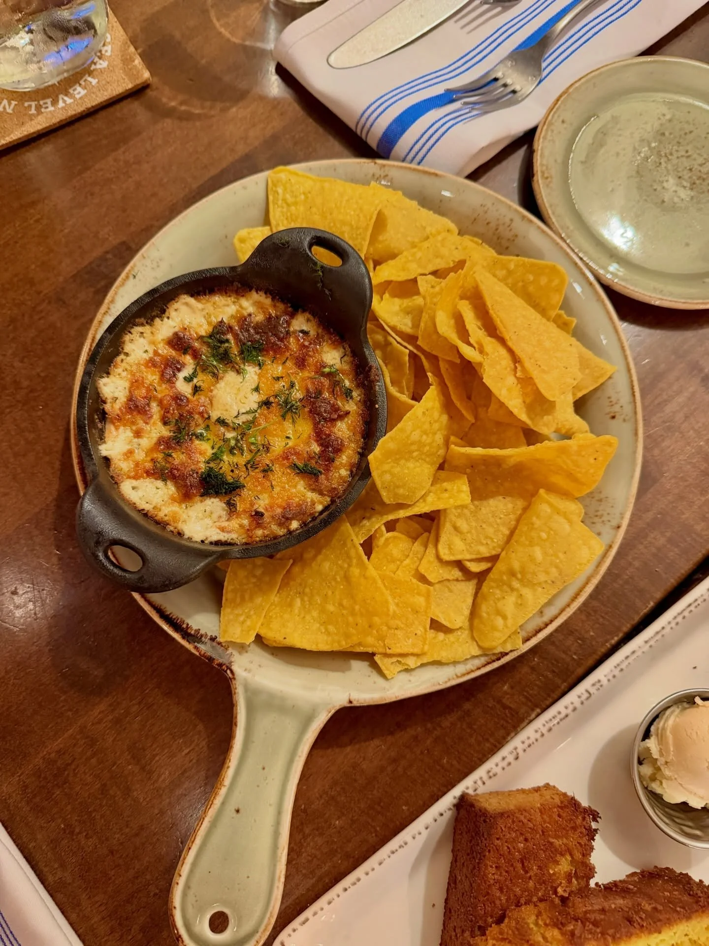 A rich, creamy blend of salmon, shrimp, and white fish mixed with Boursin and Parmesan, baked hot in cast iron and served bubbling with crispy corn tortilla chips for dipping. Perfect for sharing &mdash; or not. 😉