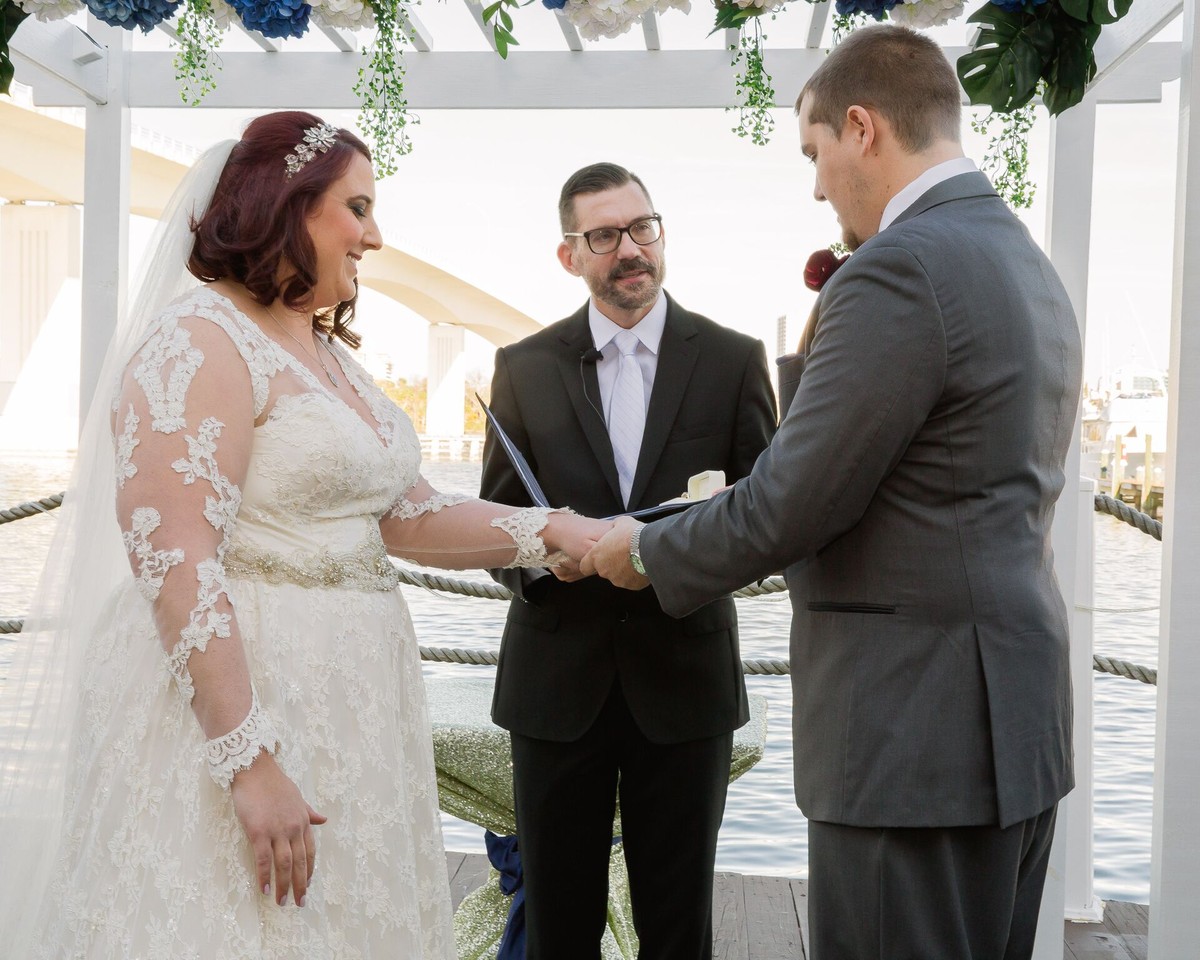 Sam officiates a personalized wedding ceremony with couple overlooking lake in Daytona Beach