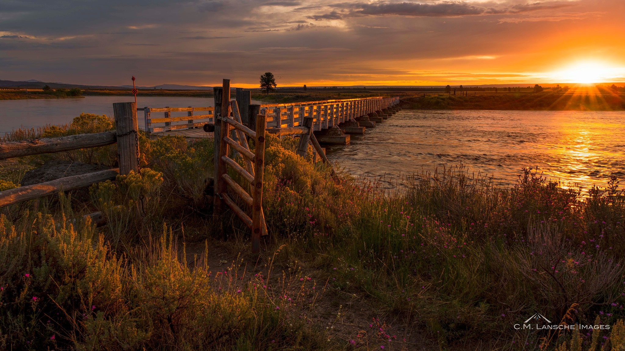 Osborne Sunrise. How many ranchers, fishermen, and passersby have crossed the Henry's Fork via the historic Osborne Bridge? It's a question that I ponder each time I walk through this gate. Island Park, Idaho. August 24, 2019.