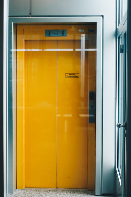 Elevator with a yellow door.