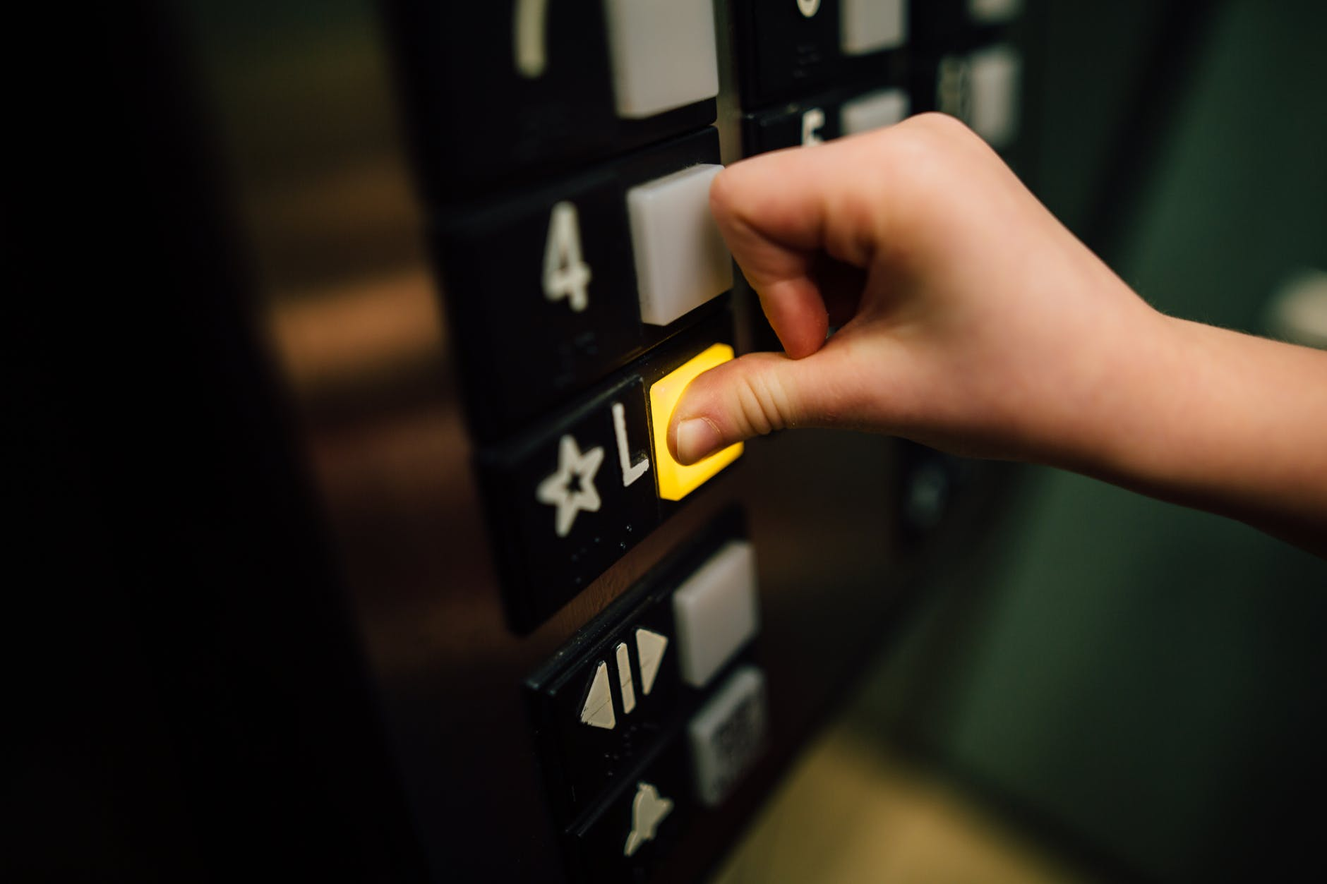 Pressing button in an elevator