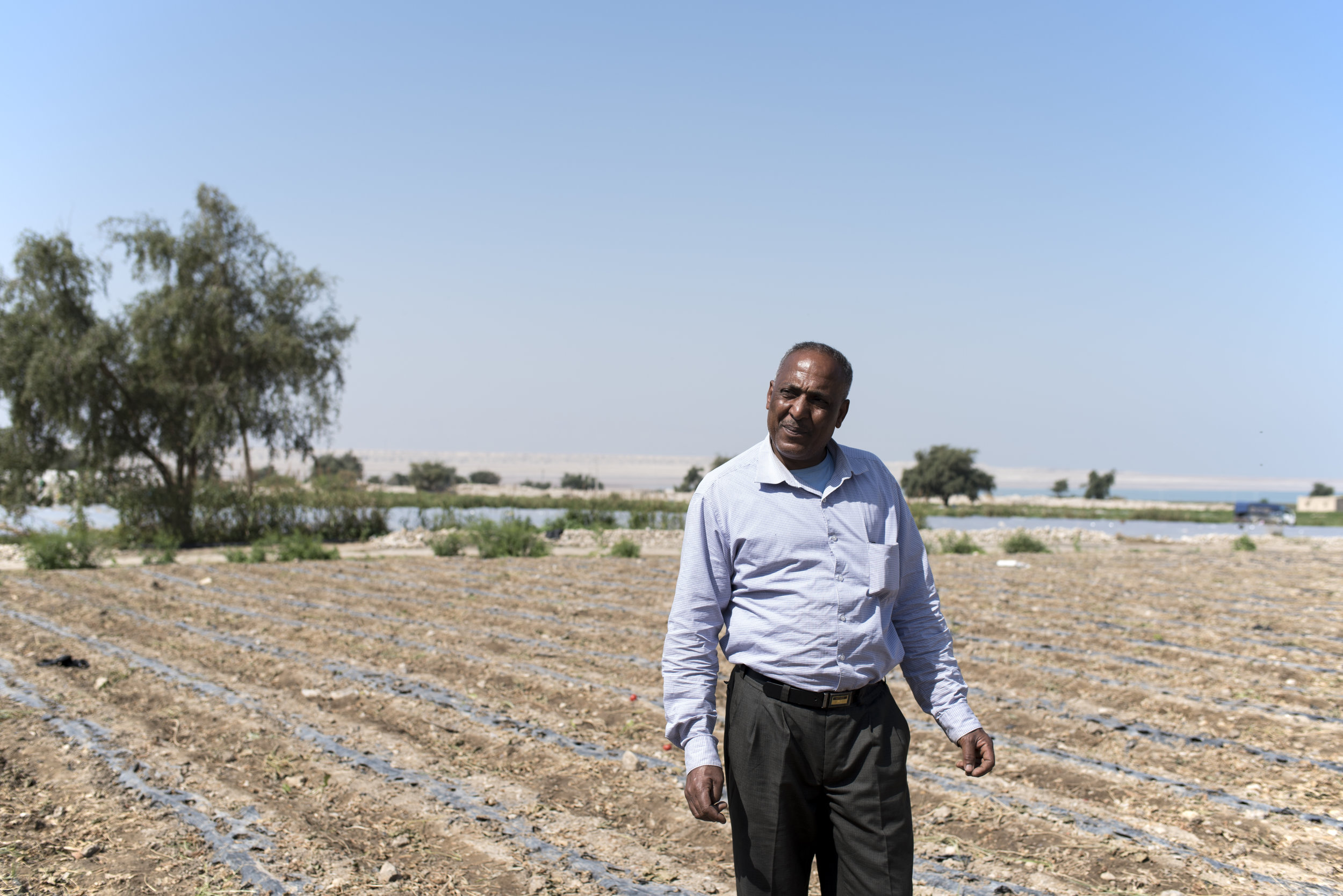 Abdul Alhay Alhwemen, a Jordanian farmer, shows his fields, which used to be only a few paces from the shoreline when he was young.