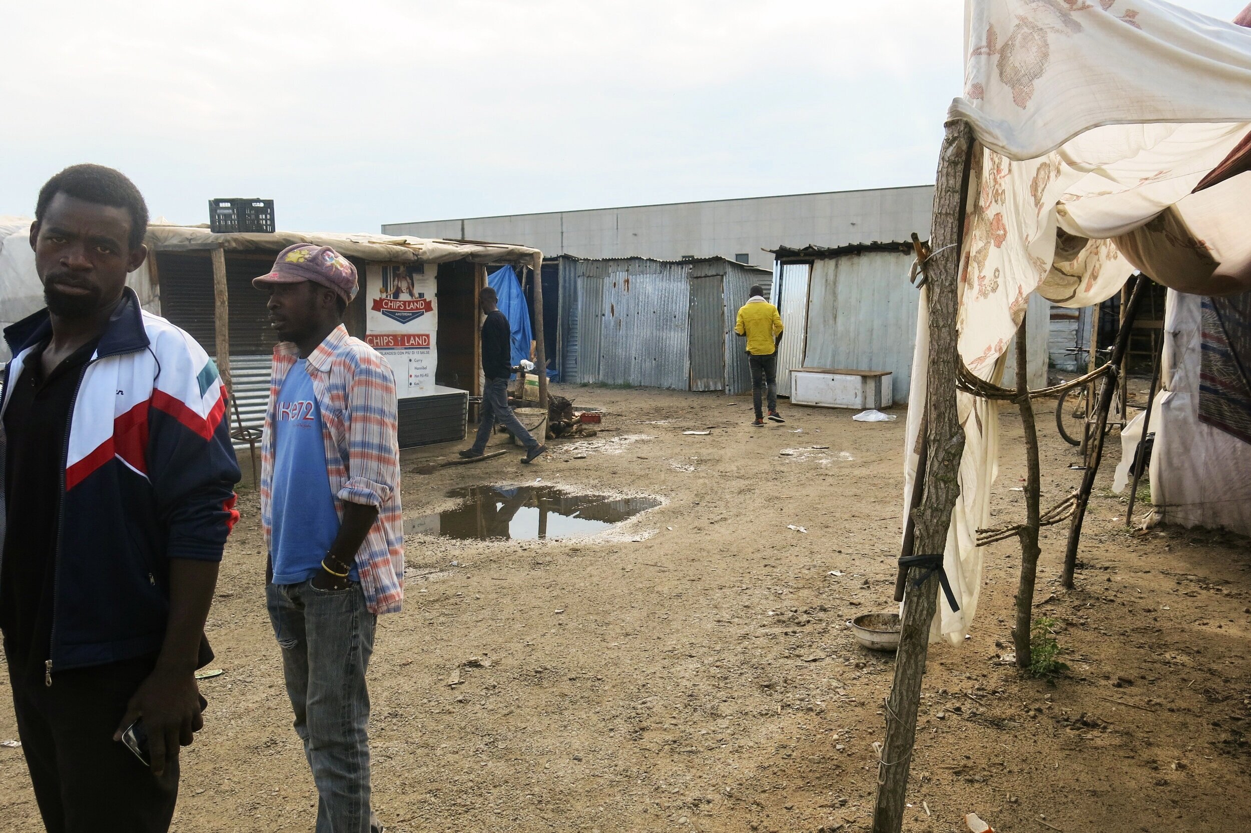 Migrant agricultural worker are seen in the former shantytown of San Ferdinando, near the infamous Rosarno mafia stronghold. The informal settlement was shut down in 2019, but similar camps have recently emerged in the area. 