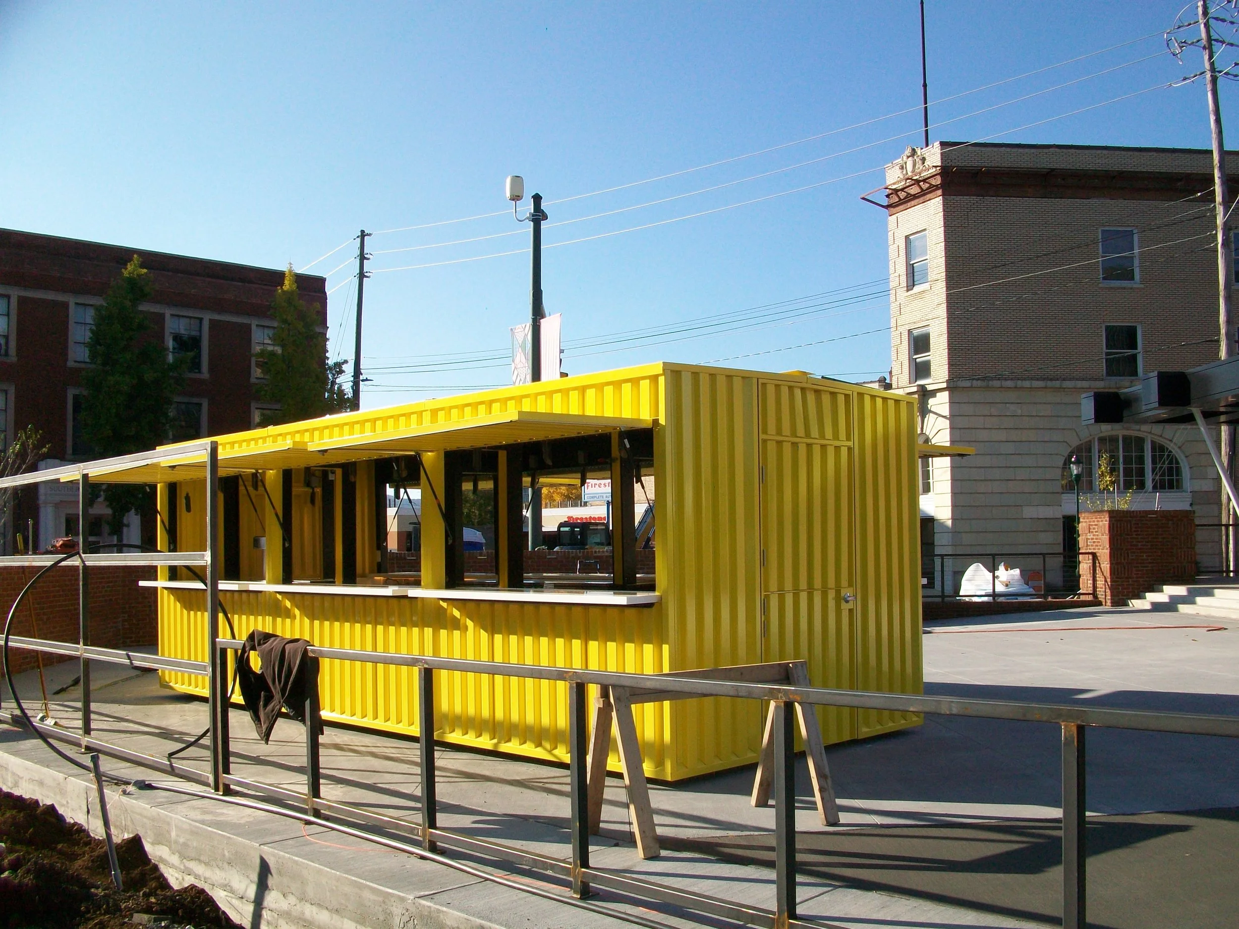 Shipping Container Bar with Picnic Tables in forefront
