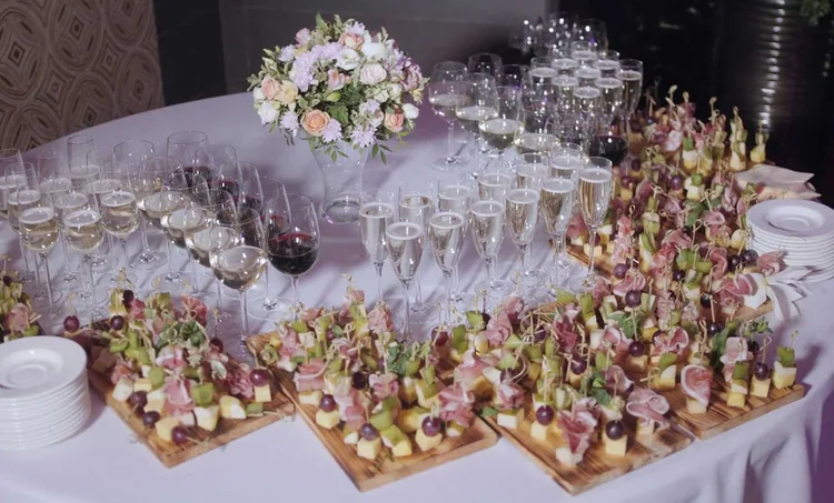 A catered buffet by Dnister with canapes and glasses