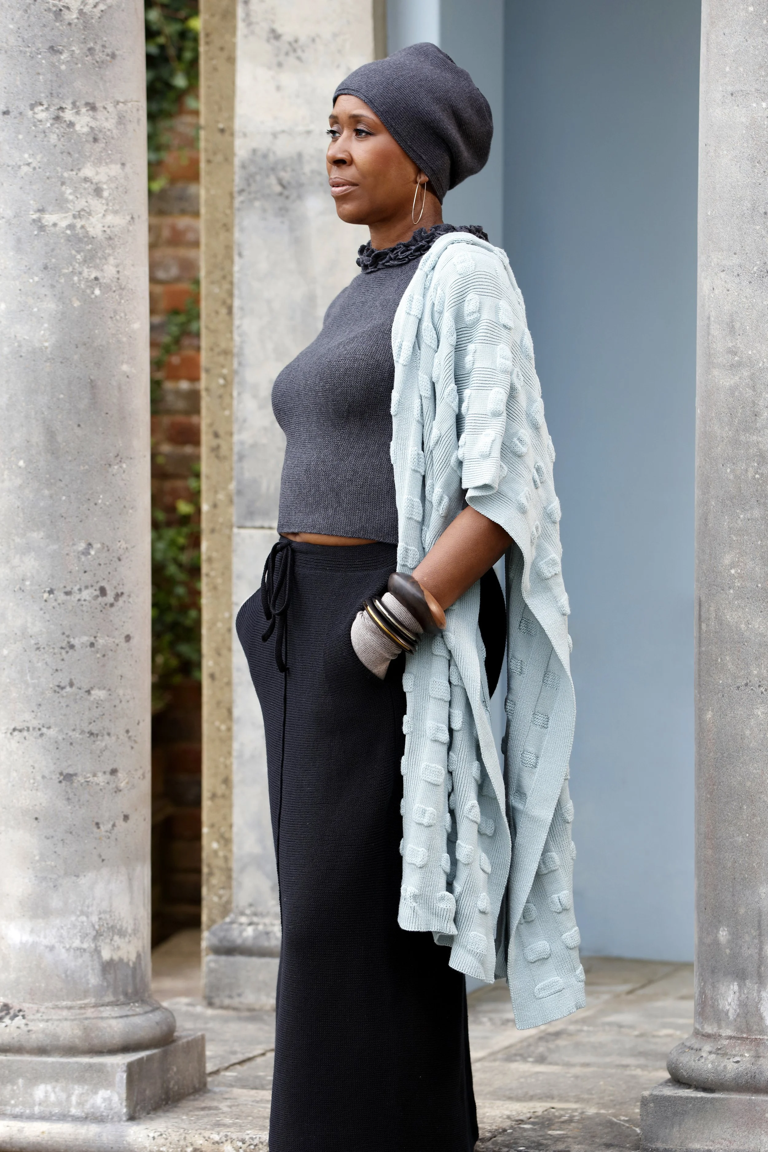 Woman wearing dark grey beanie and sweater