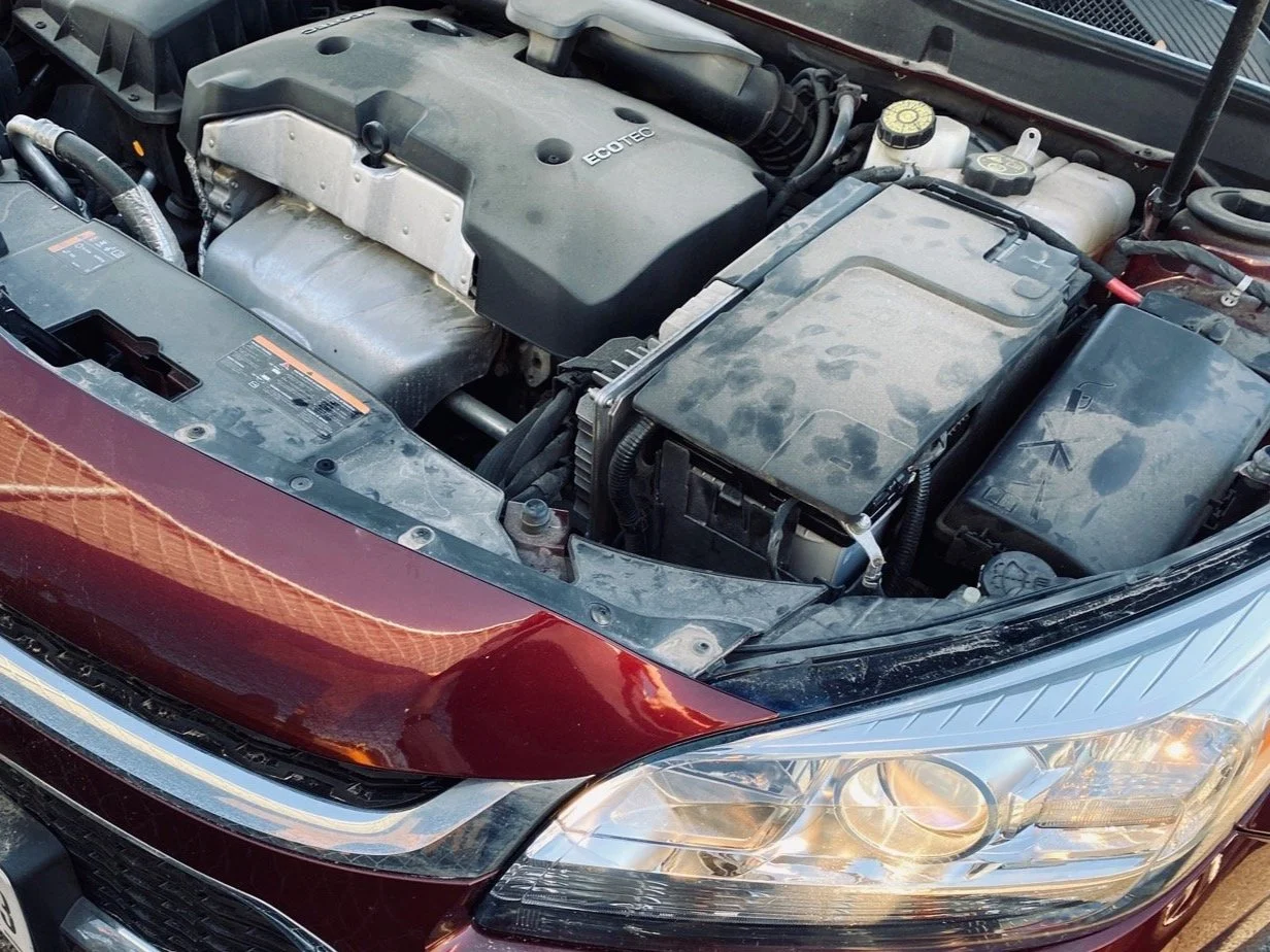 Car with hood open for battery replacement