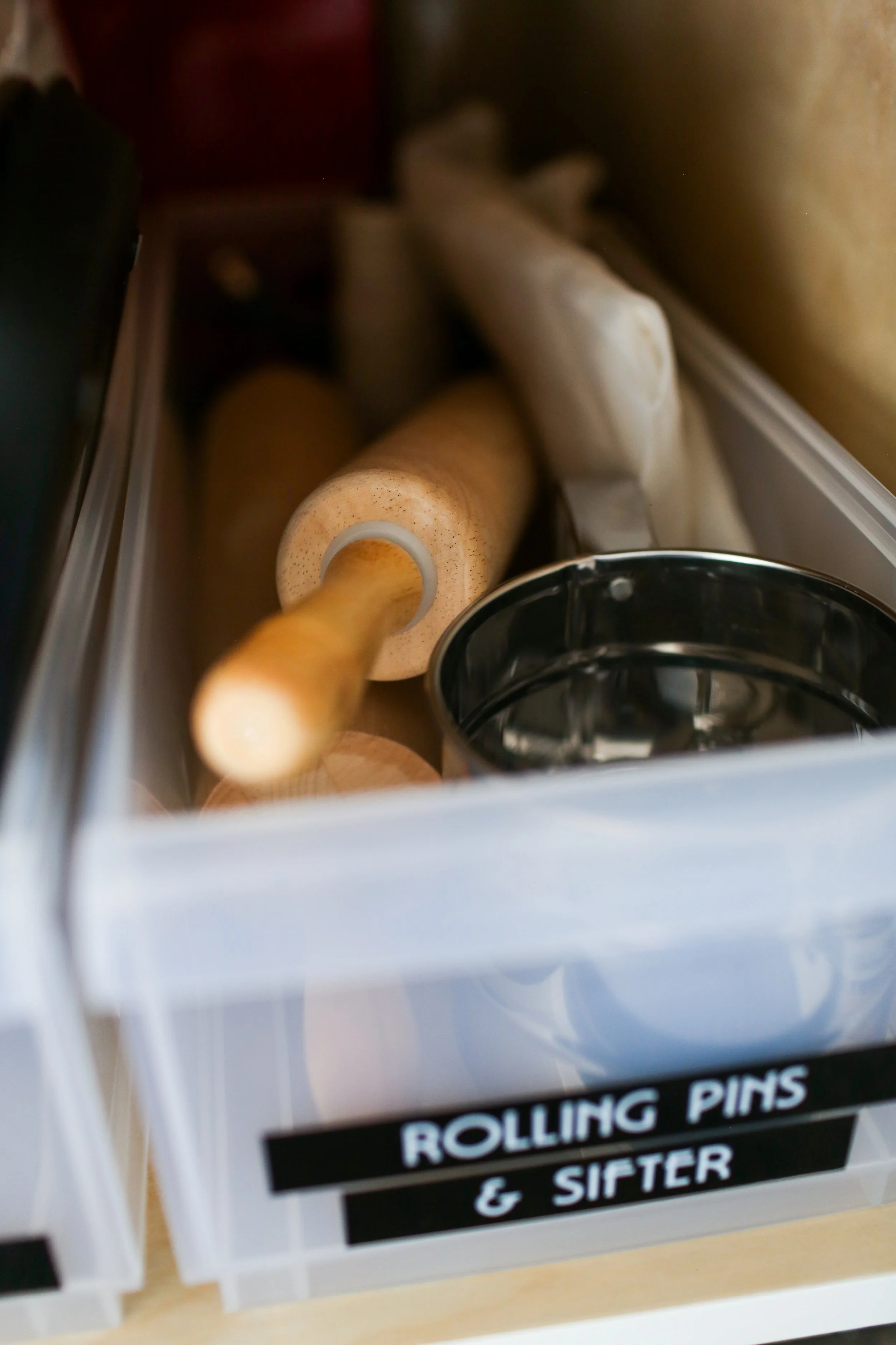 A drawer labeled 'Rolling Pins & Sifter' containing a wooden rolling pin, a sifter, and a bag of flour.