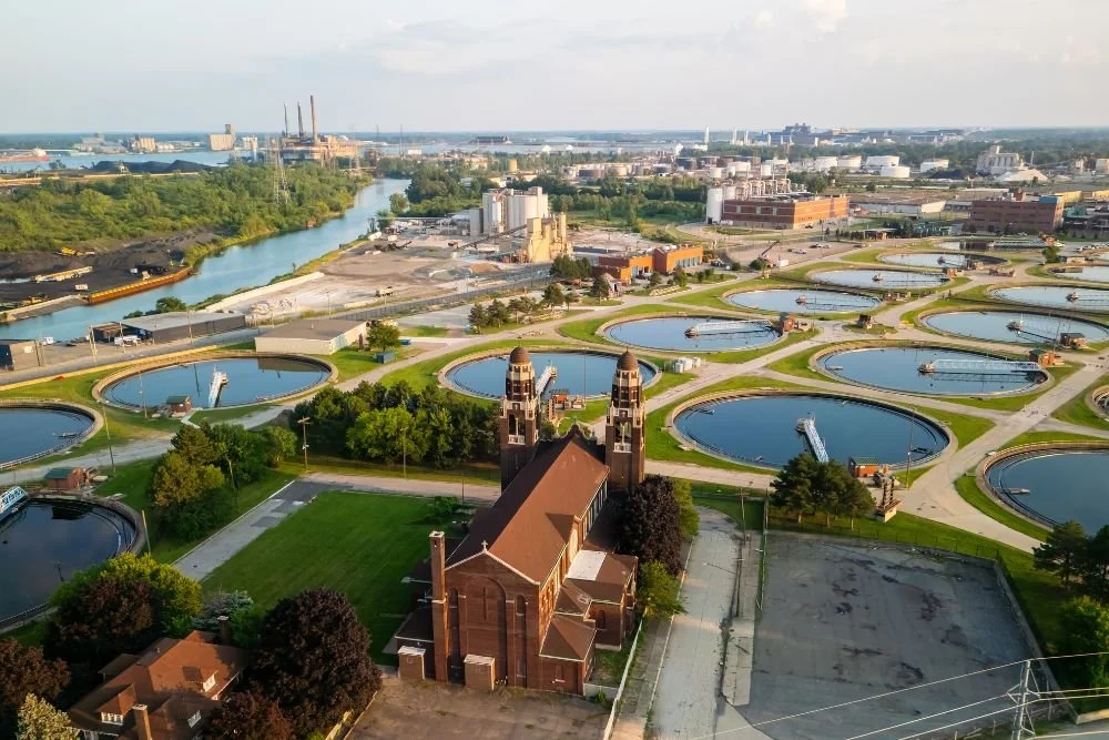 Aerial view of a water treatment facility near surrounding buildings and residential areas