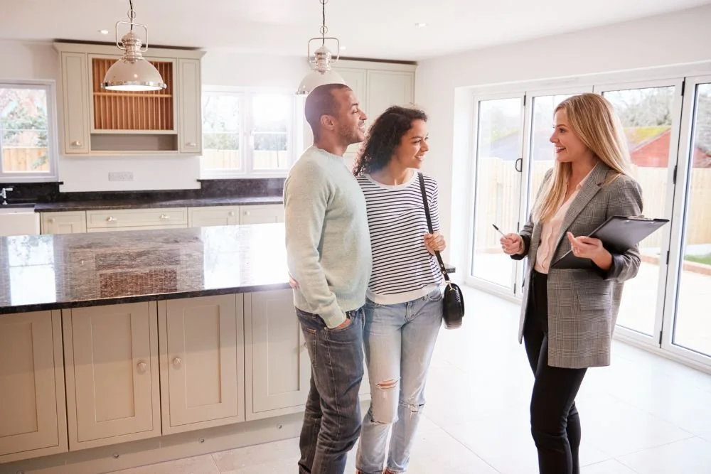 Real estate agent discussing a kitchen with homeowners before listing their property
