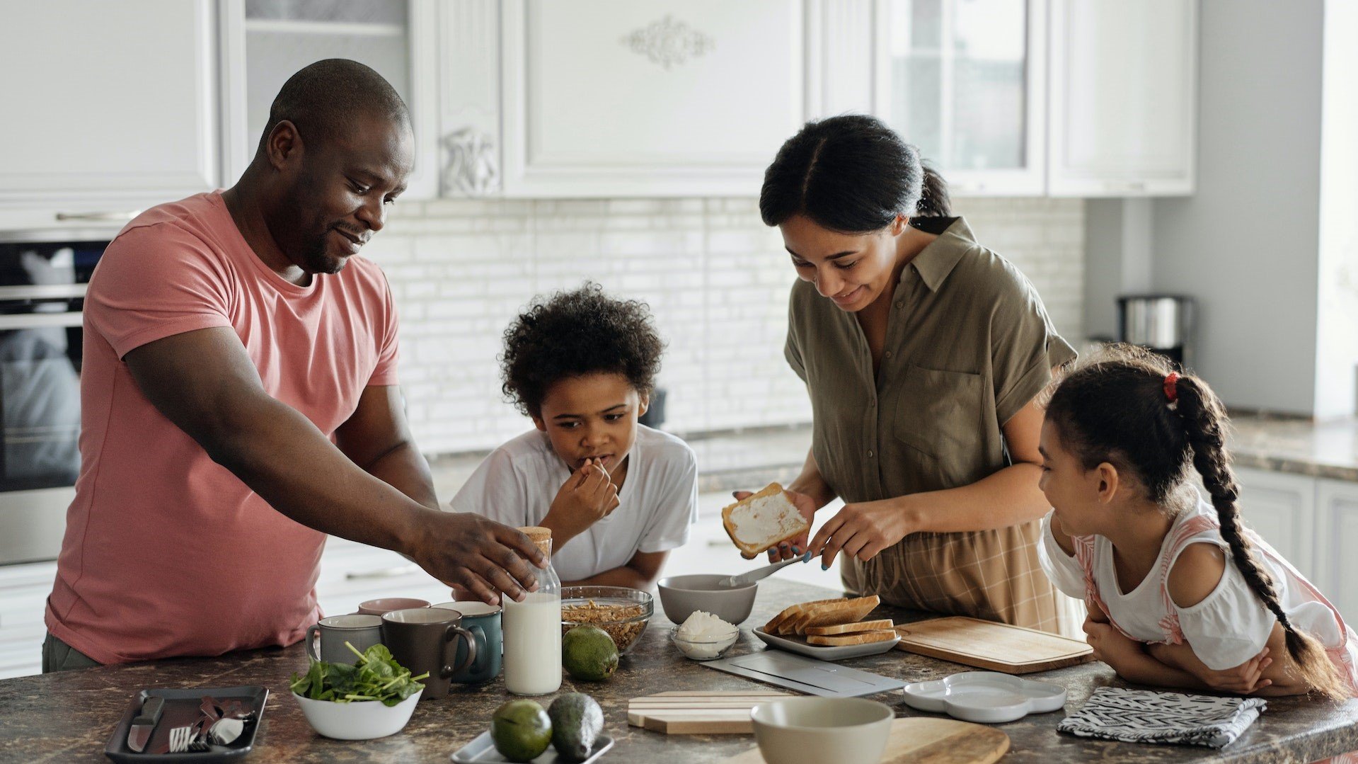 A happy family enjoying breakfast in their new home.