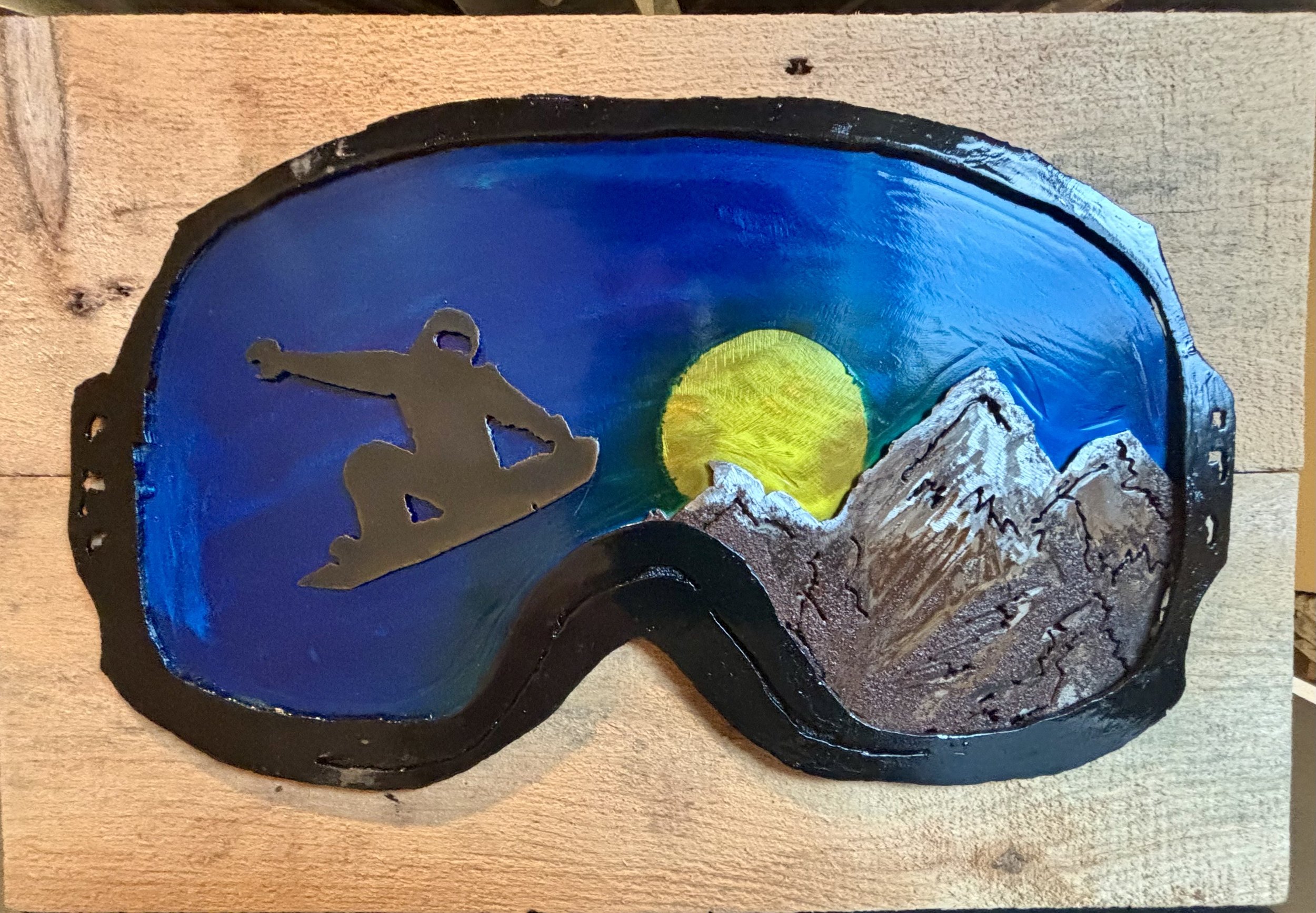 Reflection of snowboarder in goggles.