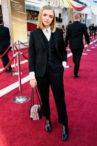 Elsie Fisher redefining feminine fashion in a Thom Browne suit.