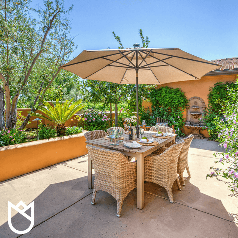 Adjacent-to-the-seating-area-is-a-long-table-big-umbrella-and-more-comfortable-chairs.-The-cushions-are-covered-with-Sunbrella-fabric.png