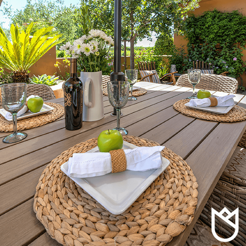The-dining-table-top-is-made-of-an-engineered-polymer-composed-of-virgin-plastics-creating-the-appearance-of-natural-teak-wood-while-remaining-water-repellent-and-stain-resistant.-.png