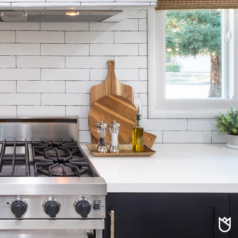 I like the mix of a rectangular and round cutting board. Get a simple jar and top it with a liquor spout to pout out small portions of oil when cooking. Also, feel free to mix metals such as this copper tray and stainless salt and pepper shakers.
