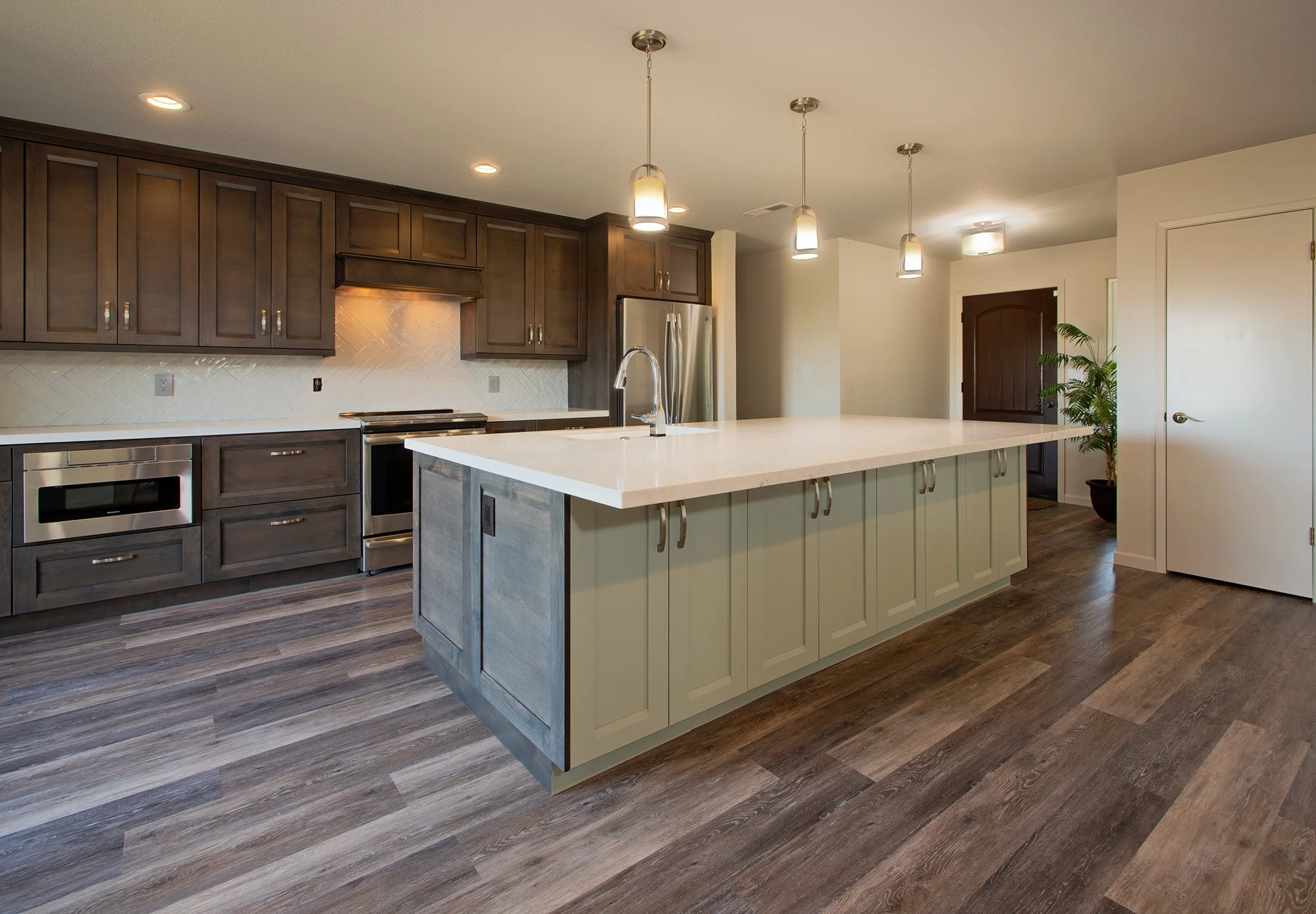 Quartz Countertops: Marble Palace . Cabinetry: Bellmont (dealer – KTJ Design Co). Appliances and Lighting: Ferguson Showroom. Tile Backsplash: Emser Tile . LVP Flooring: Cortec Flooring . Painting: Jenco Companies