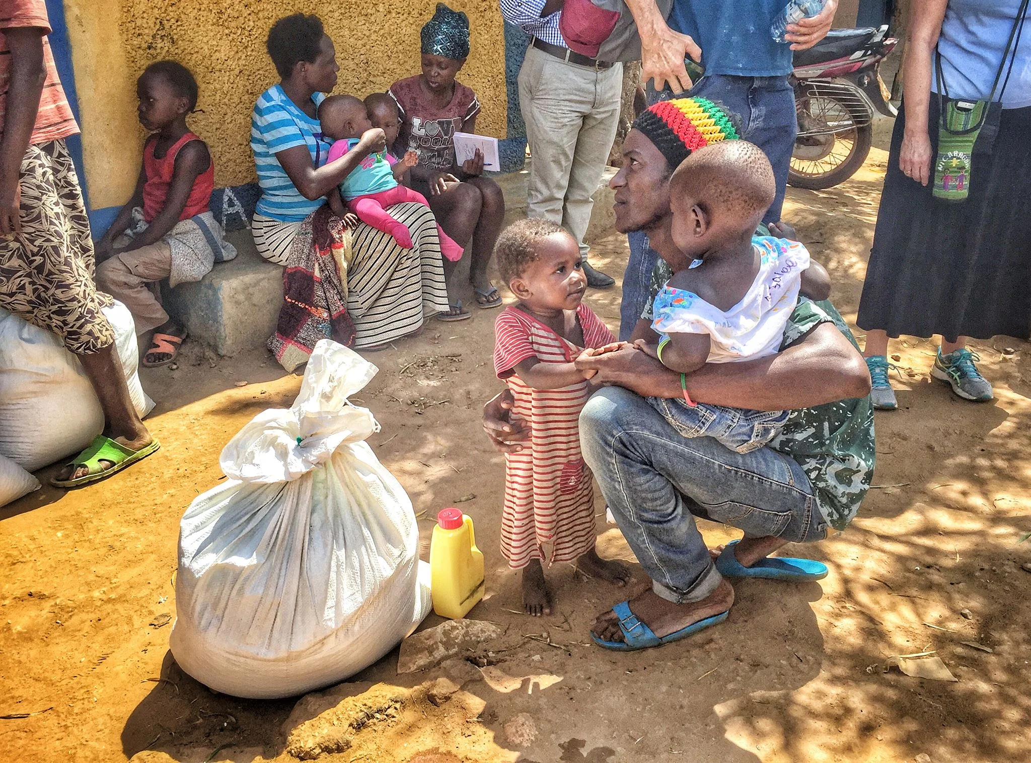 Young father receiving apr. 94 lbs. of food and cooking oil that will feed his family for one month.