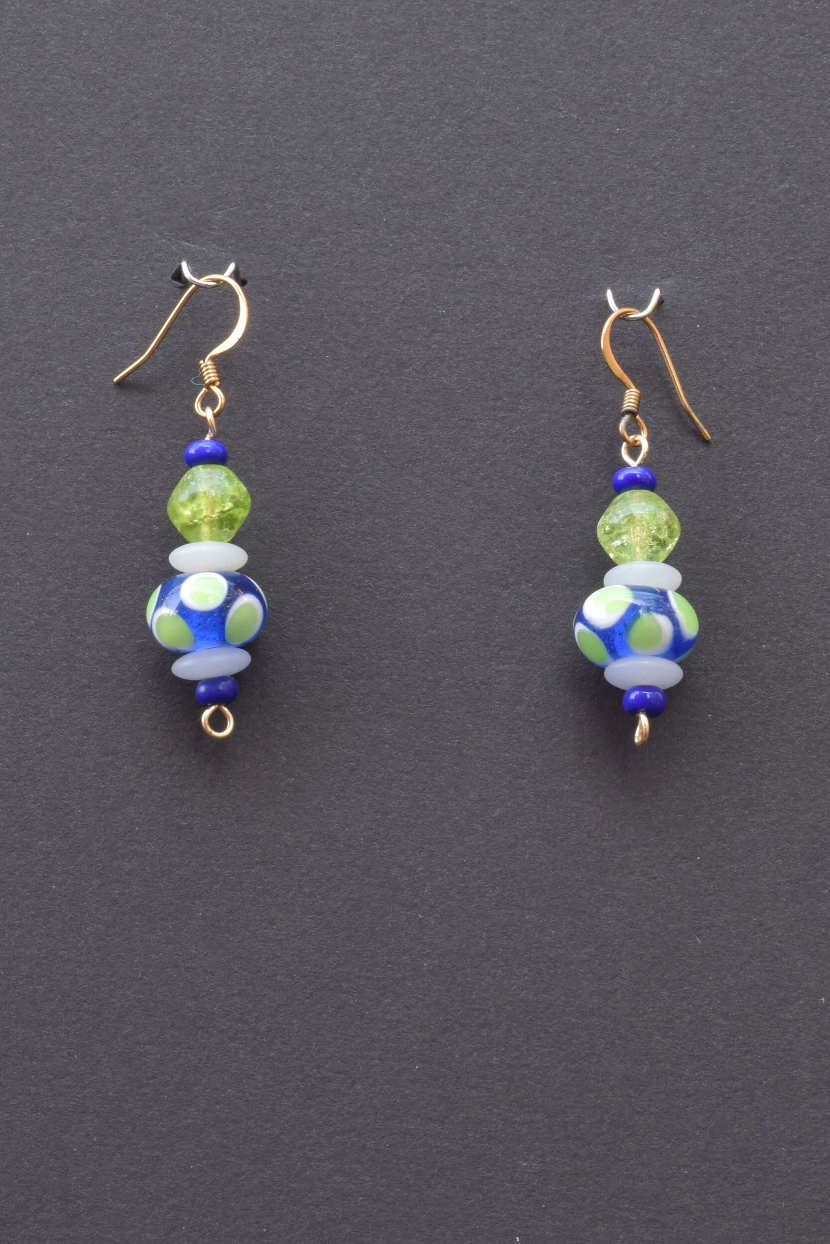 Green on blue lampworked glass earrings