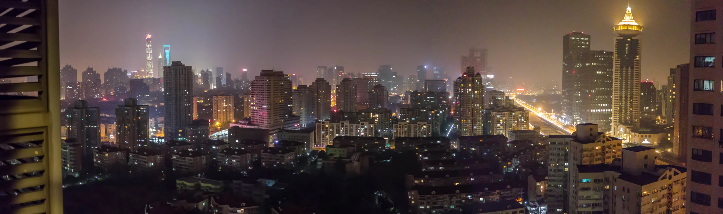 Night view of Pudong from our temporary apartment. Two of the tall skyscrapers are visible to the left in the distance.
