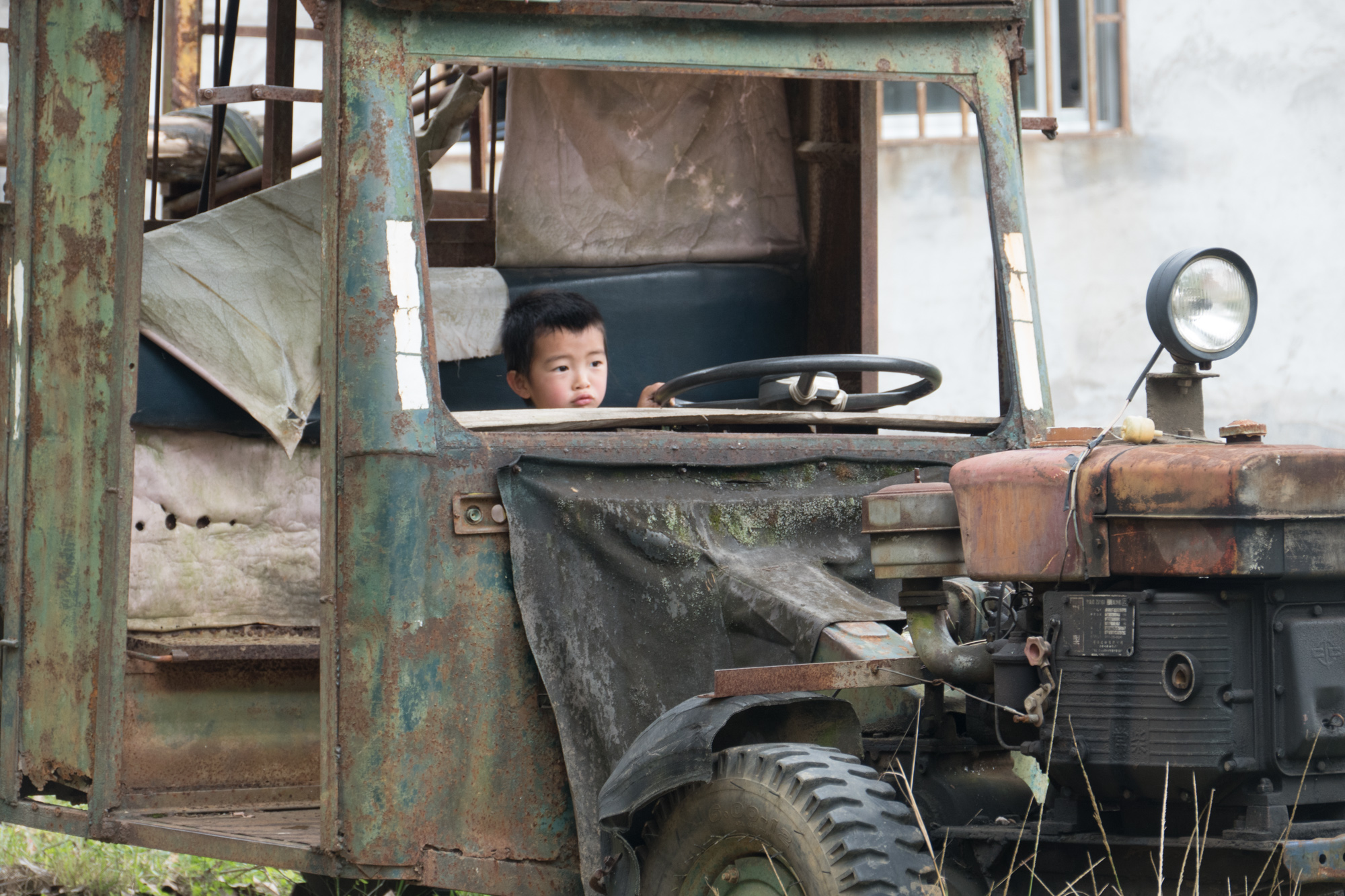Boy playing in old truck