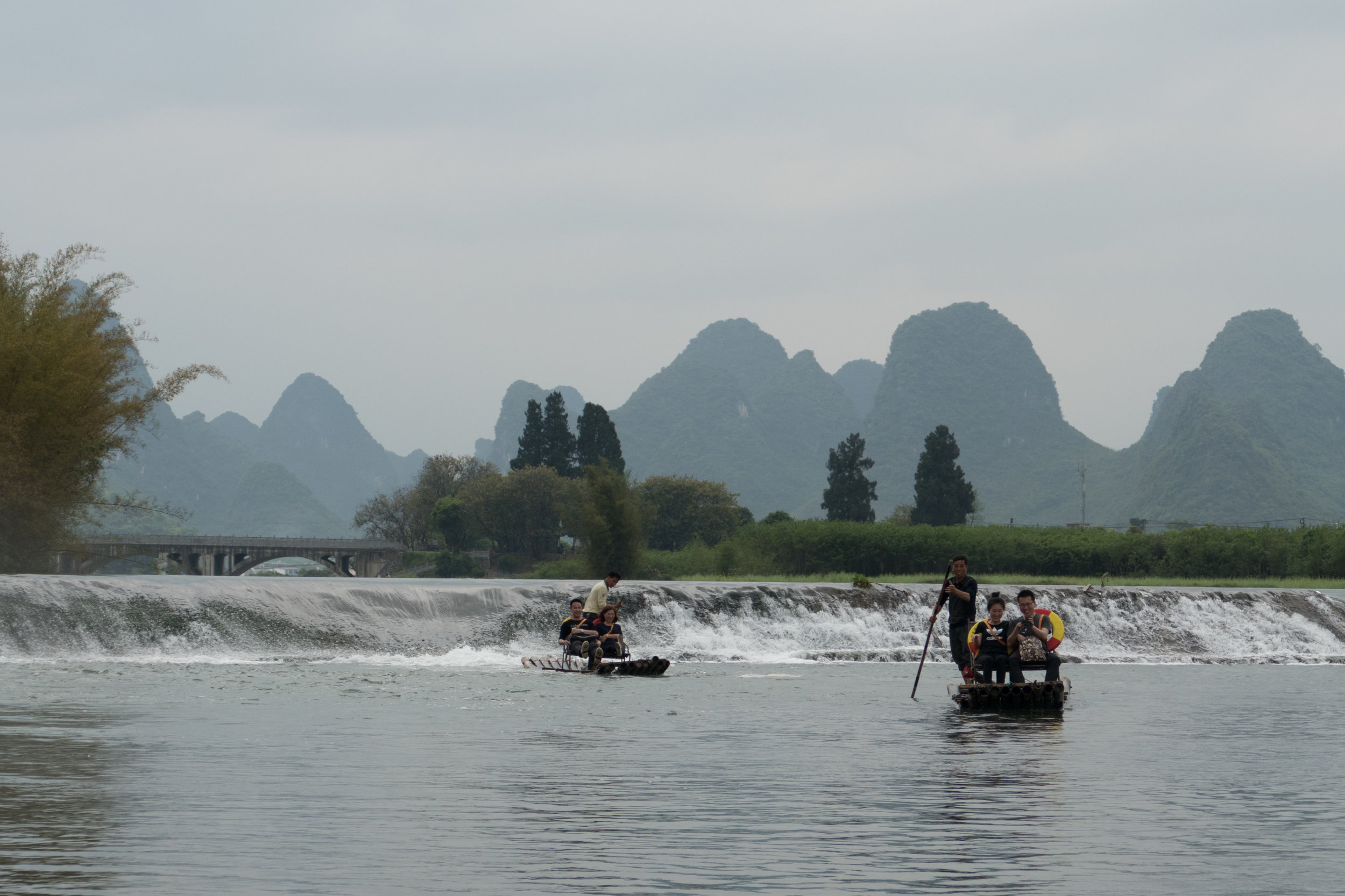 Rafts on the Yulong River with karsts in the background