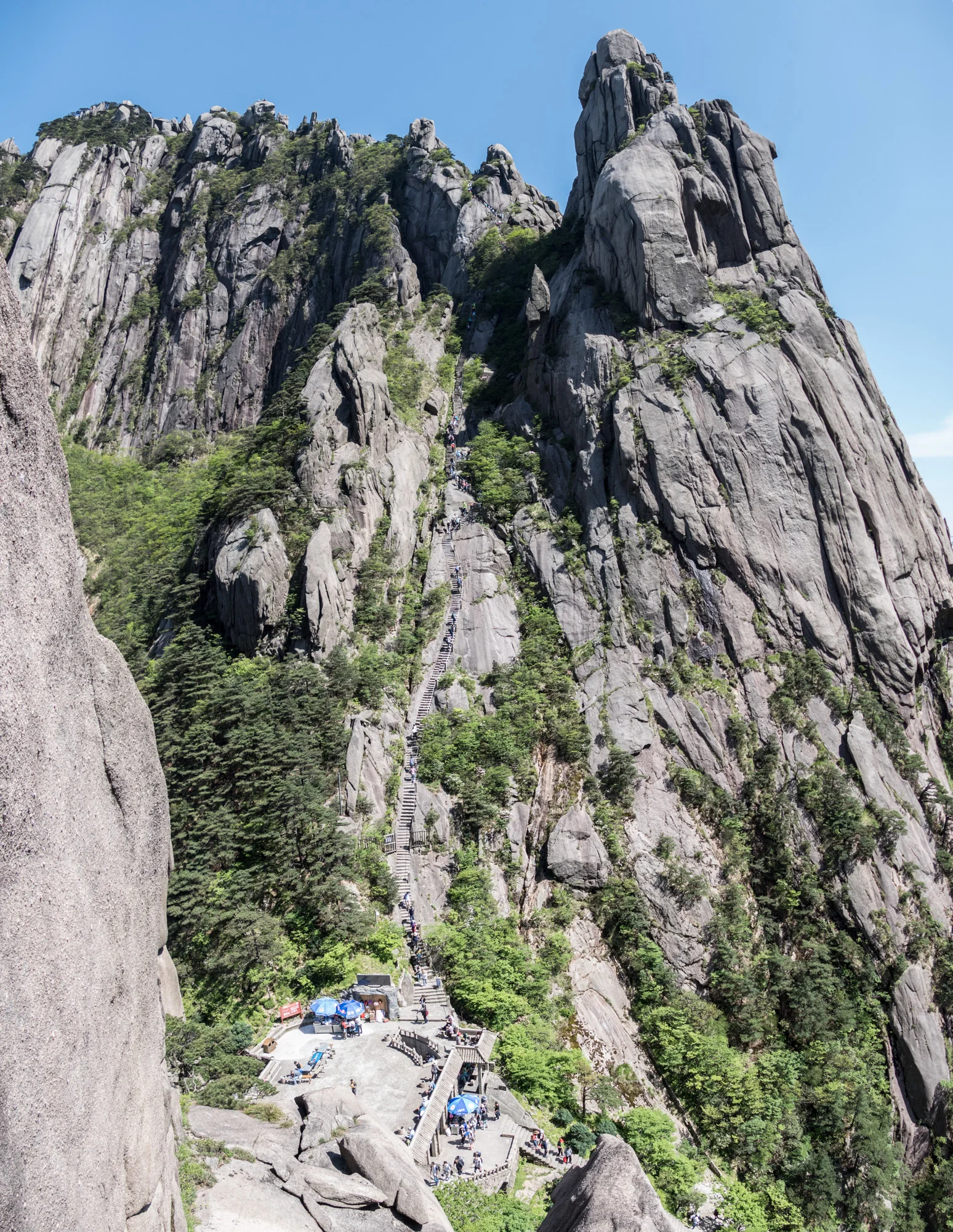 Vertical panorama of Heavenly Capital Peak, an impressive upward climb. See the line of hikers snaking up to the peak.