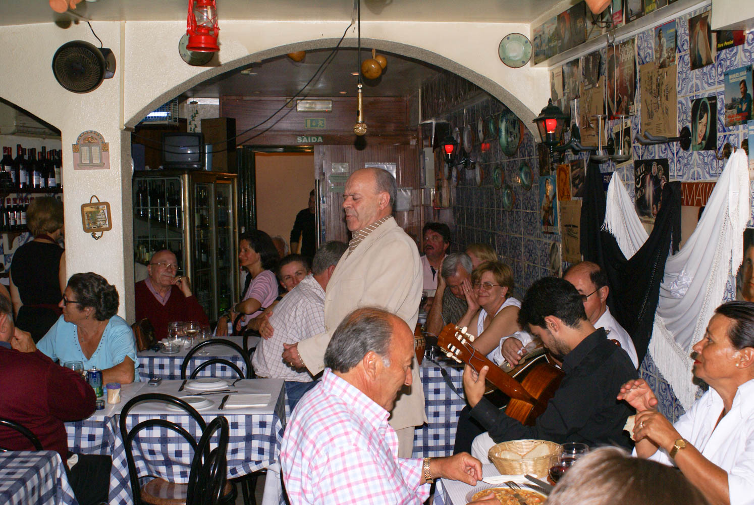 Fado singing in the Alfama.The muscians are on the right and different singers took part. Everyone else in the room semed to know the song and would sing along