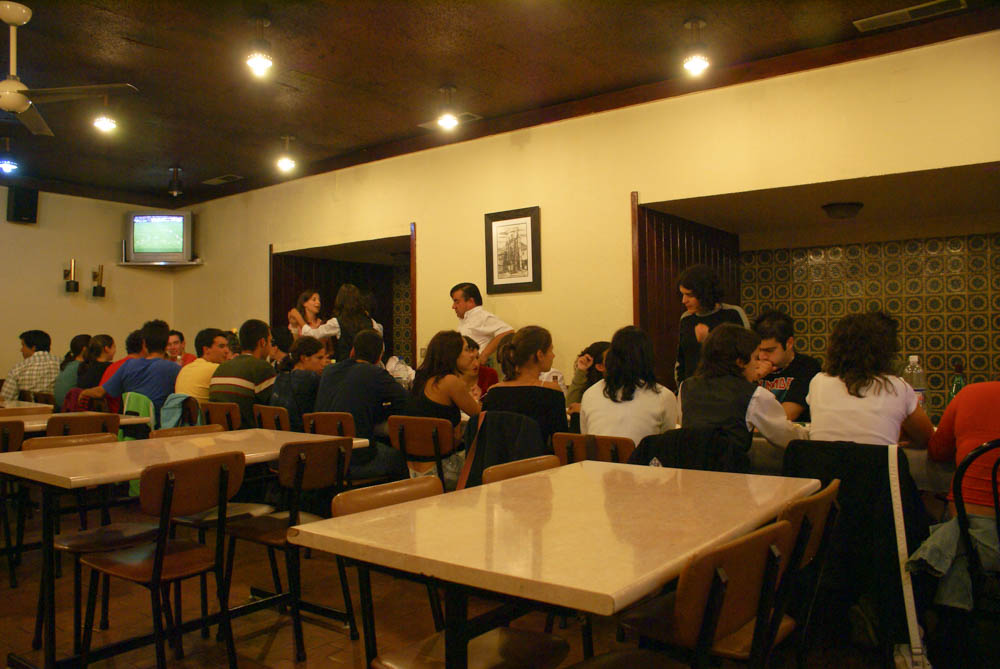 At a restaurant near the university with a large group of students celebrating the end of the year