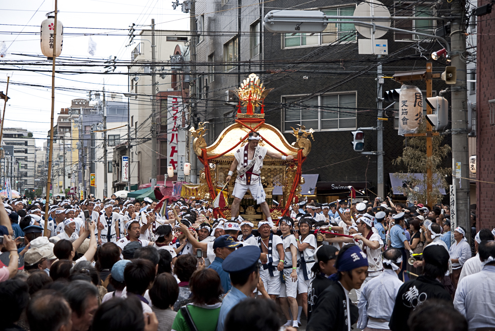 One of the shrines being carried down the street to a cacophony of sound