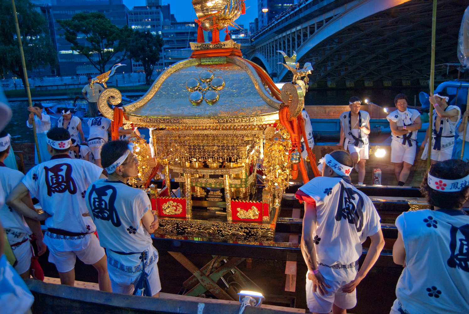 Loading a shrine onto a boat at night