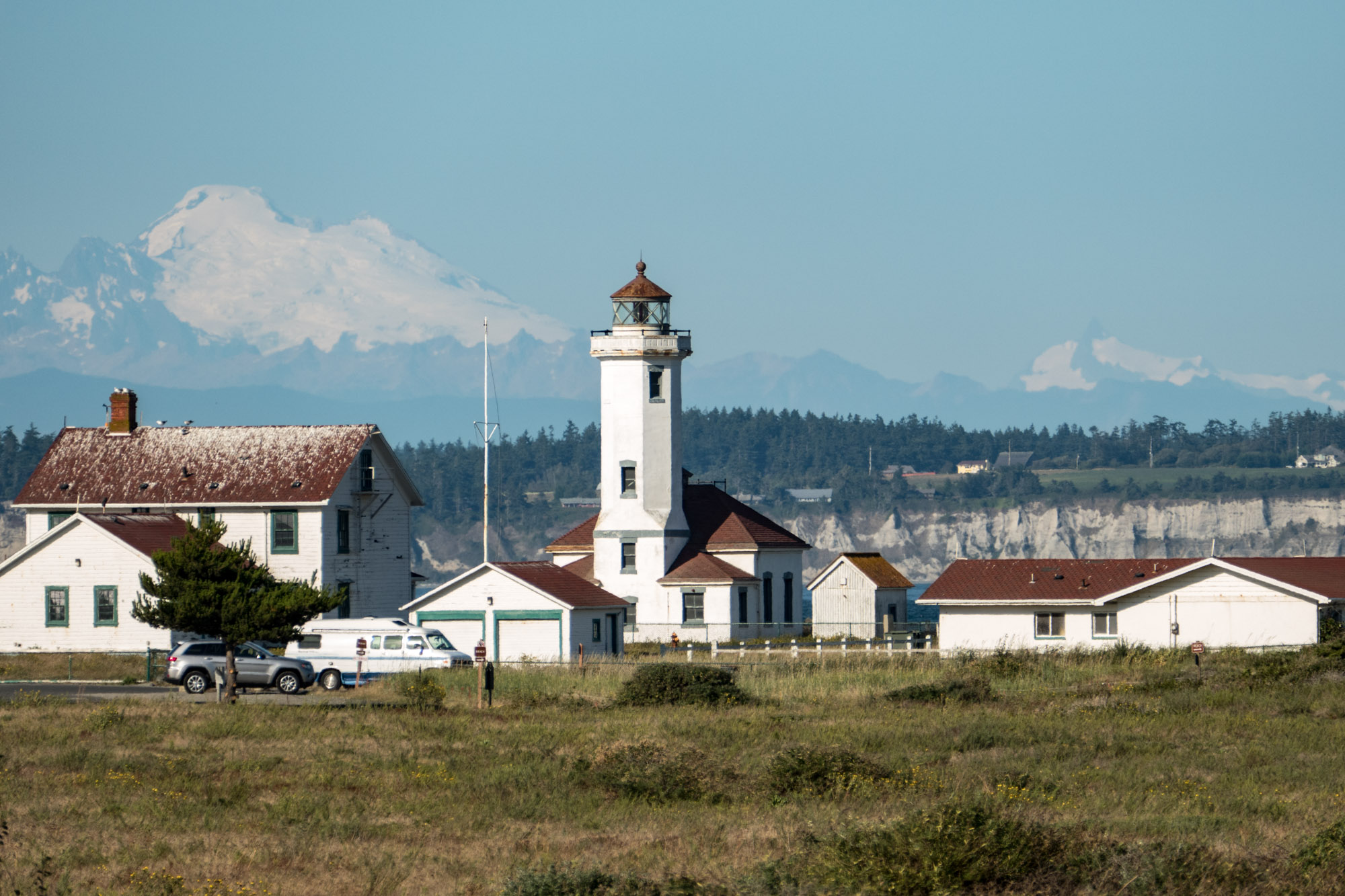 Point Wilson lighthouse with Mt. Baker in the background. With a telephoto lens one can make the background objects appear much larger.