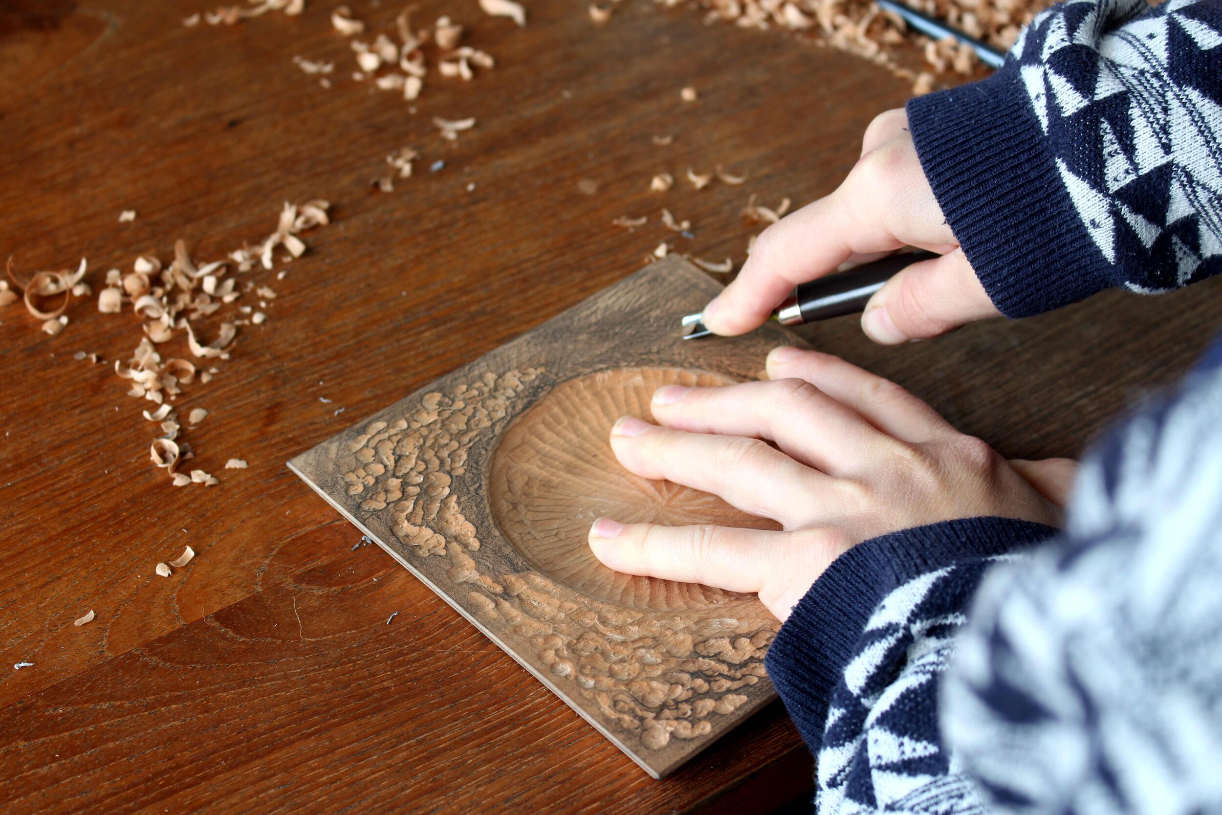 Graphite on the surface of the wood makes carving easier to see