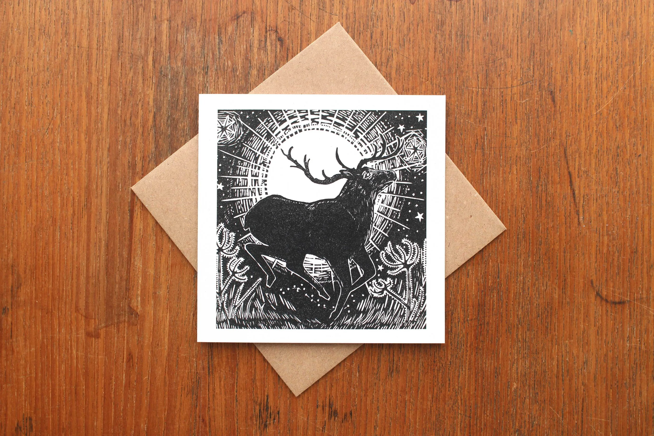 Rising Sun, Running Deer linocut greeting card Cat Moore single block print reindeer Christmas winter holly ivy frost sunrise