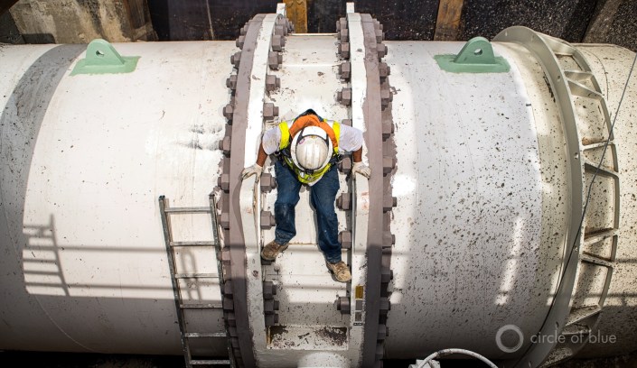 Javier Serafin, a Los Angeles Department of Water and Power utility worker climbs on a 144-inch outlet, which connects to an ultraviolet treatment plant that will be completed in 2019. Photo © J. Carl Ganter / Circle of Blue
