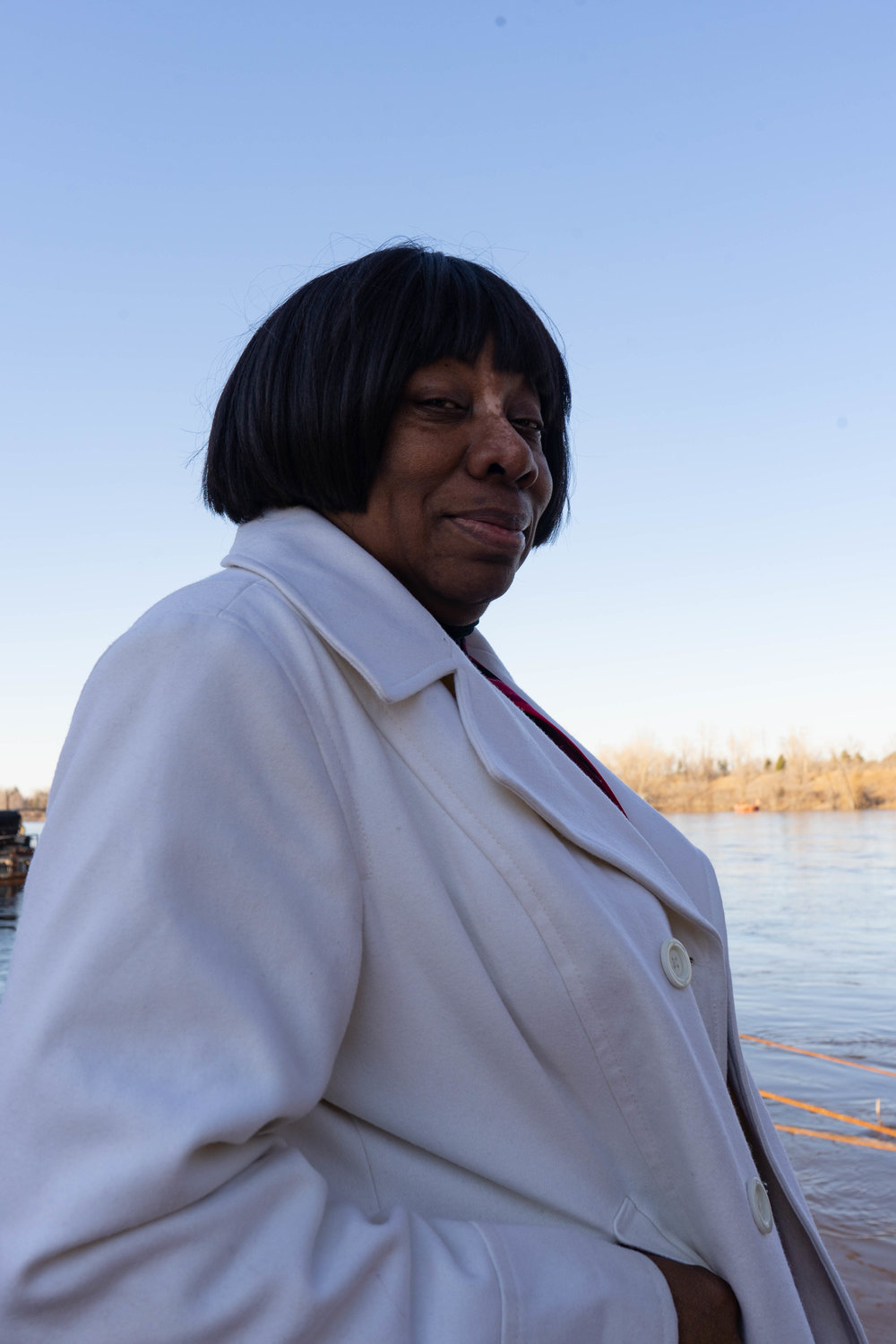 Catherine Fleming stands on the edge of the Mississippi River for a portrait at the Upper Harbor Terminal site. 