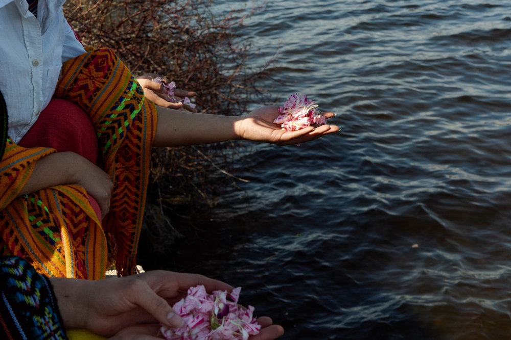 Flower offerings to Lake Phalen during the water ritual. 