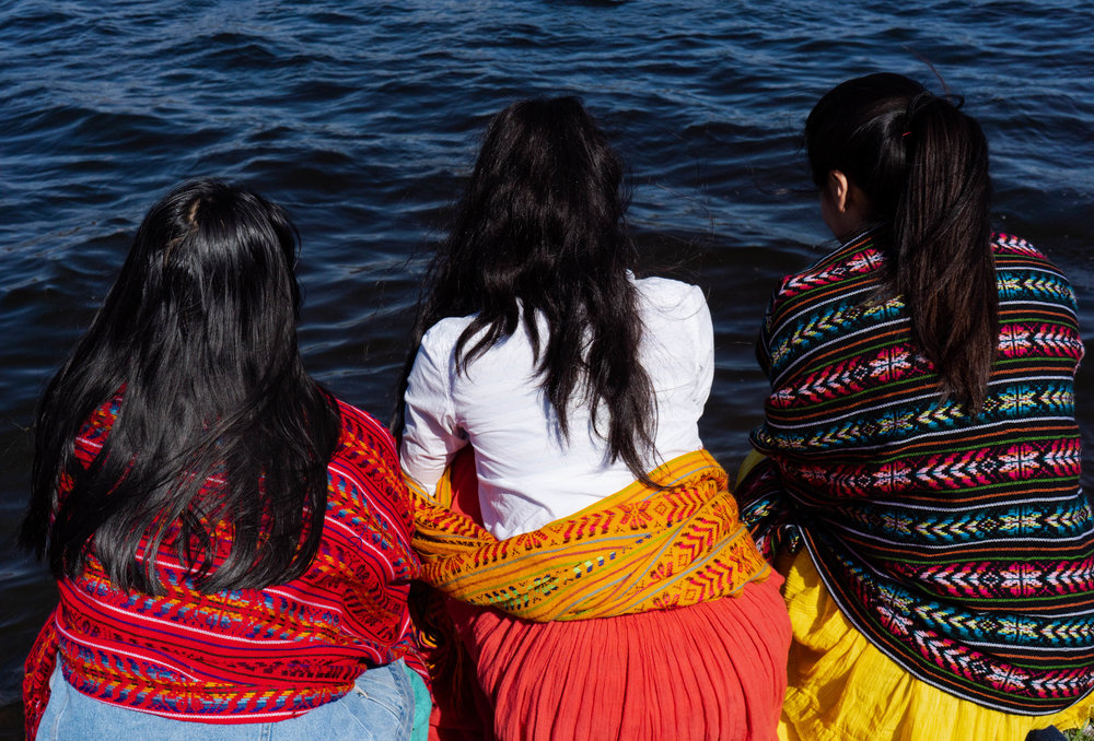 Reyna Day (left), Atquetzali Quiroz (middle), and Amoreina Espinosa (right) staring out to Lake Phalen before the water ritual.