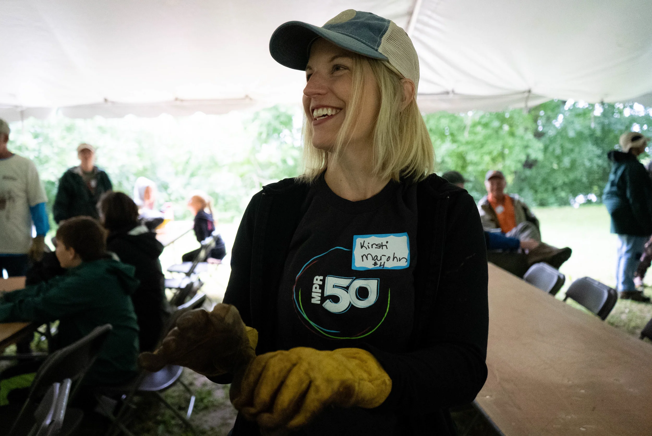 MPR News environmental reporter Kirsti Marohn pulls on a pair of work gloves, preparing to help restore the oak forest at Talahi Woods in St. Cloud, on the banks of the Mississippi River. Iyana Esters | The Water Main