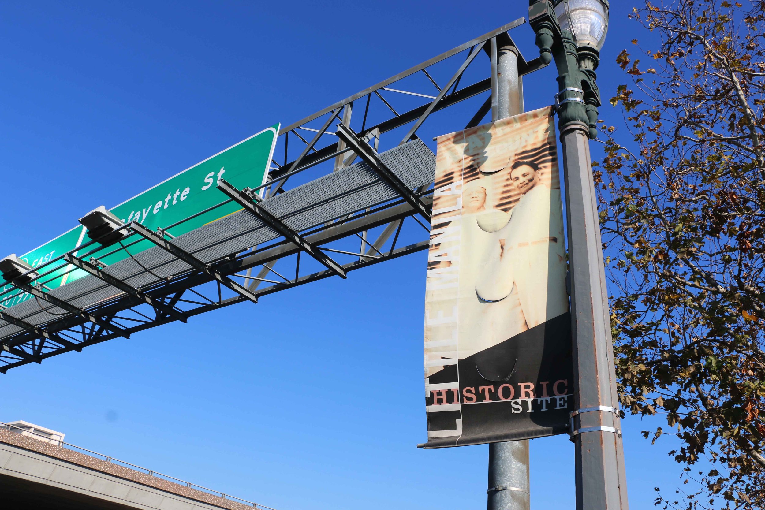 A banner marking the Little Manila Historic Site featuring Pablo “Ambo” Mabalon (left), Dawn Bohulano Mabalon’s grandfather and owner of the old Lafayette Lunch Counter restaurant in Stockton, California. Photo by Patrick Epino.