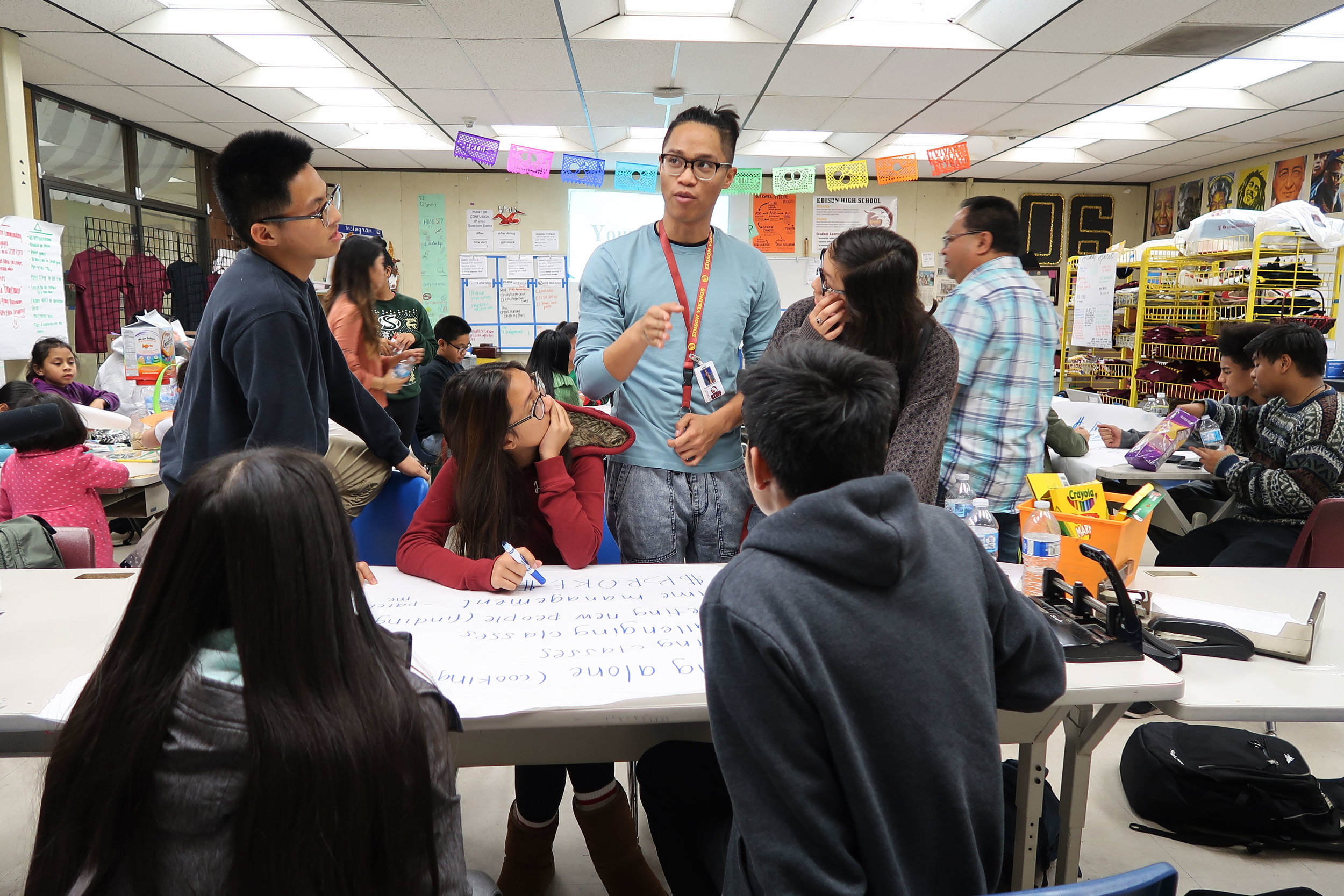  Little Manila Rising arts director Brian Batugo (center) teaches a group of students at the Little Manila After School Program at Edison High School in Stockton, California. Photo by Patrick Epino. 