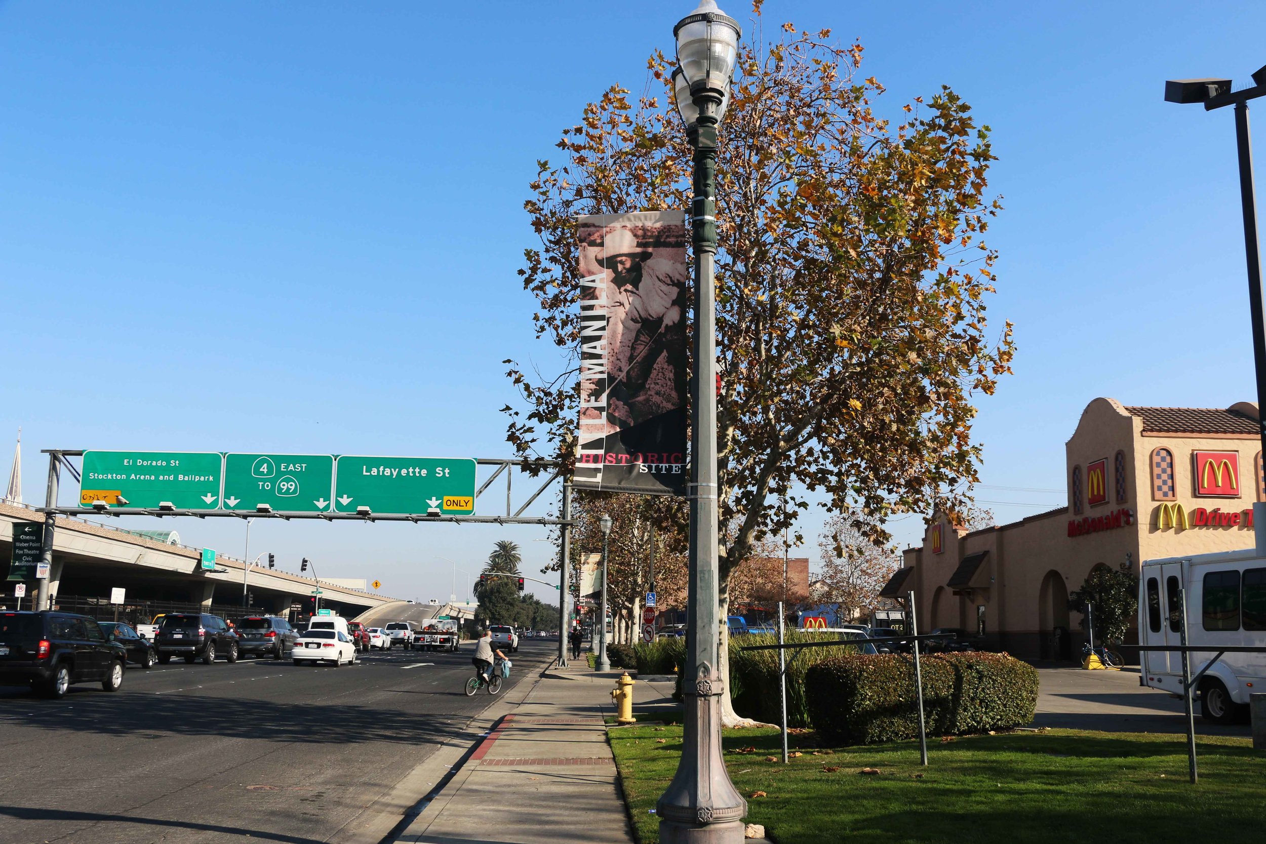  A banner marking the Little Manila Historic Site in Stockton, California is surrounded by a freeway, a gas station, and a McDonald’s. Photo by Patrick Epino. 