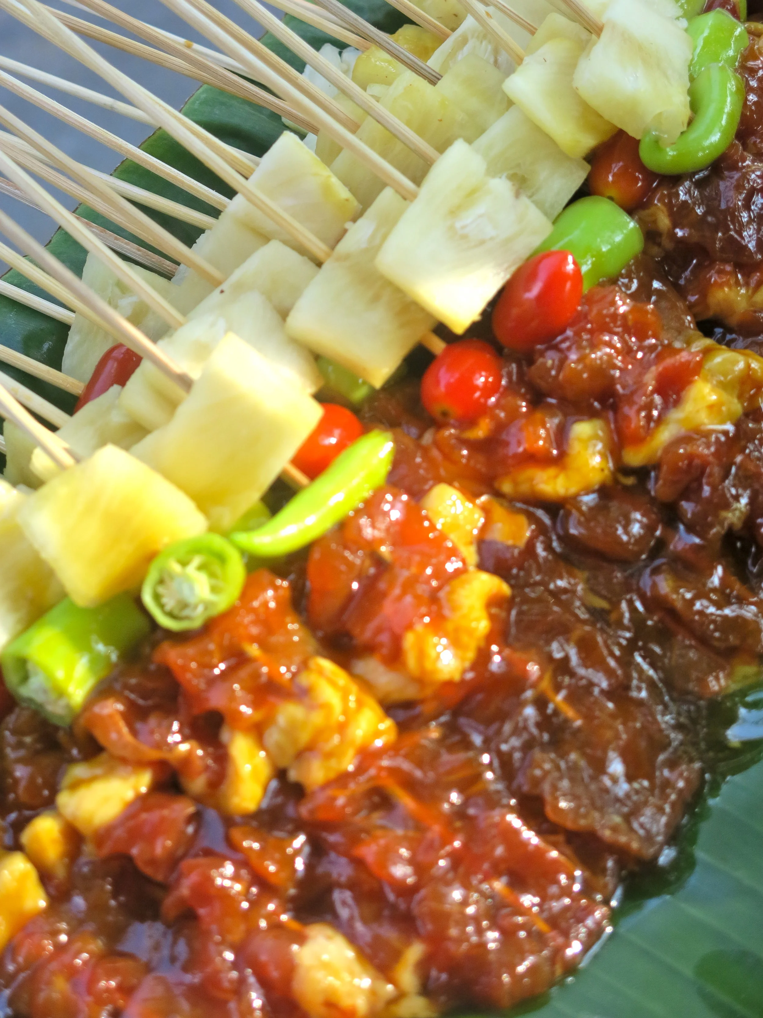 Chicken skewer on the grill with fruit and veggies
